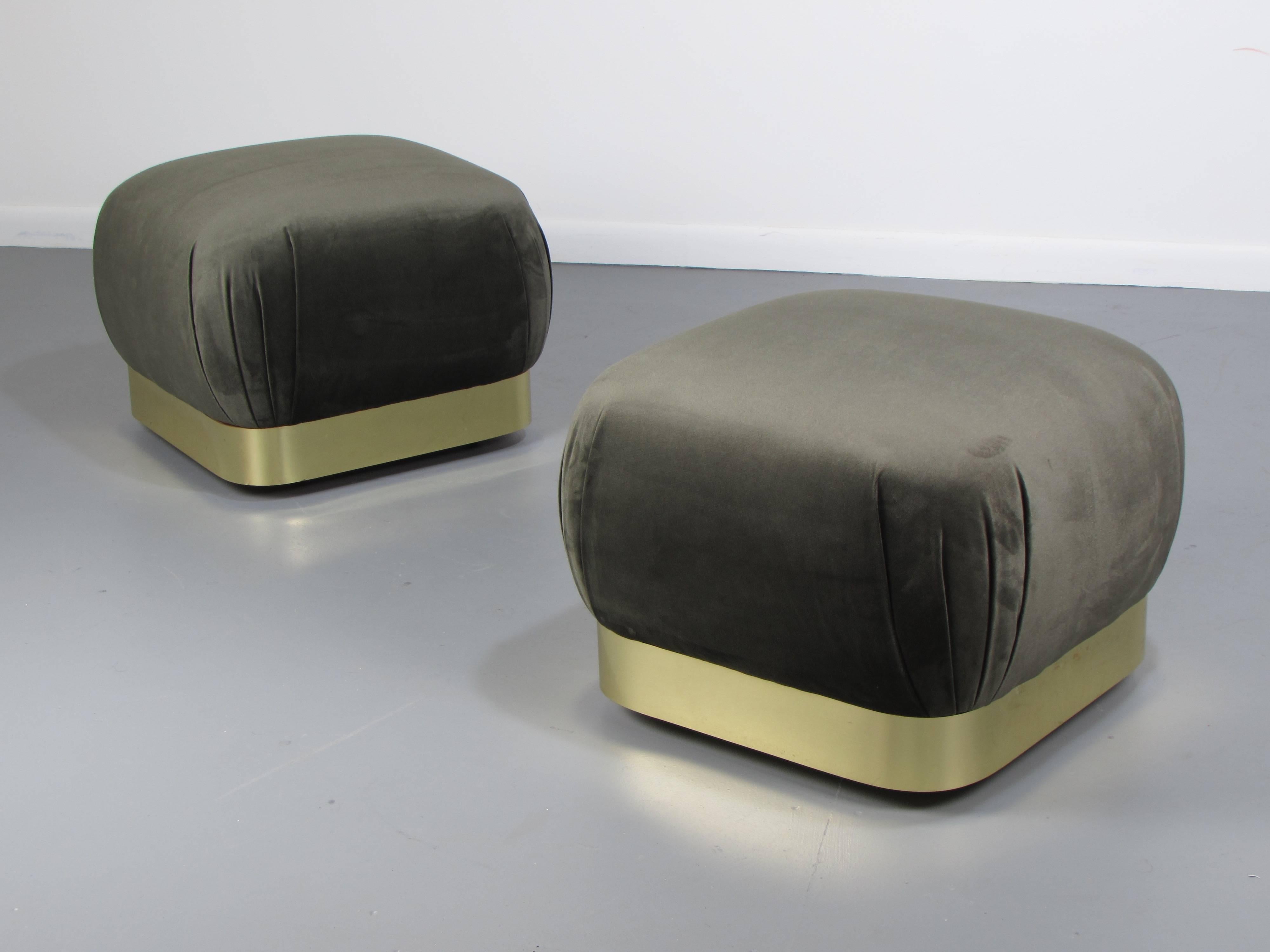 Pair of exceptional velvet and brass Soufflé́ Poufs by Karl Springer, 1970s. Newly upholstered in a dark charcoal velvet. Brass is in excellent vintage condition. 

We offer free regular deliveries to NYC and Philadelphia area. Delivery to DC,