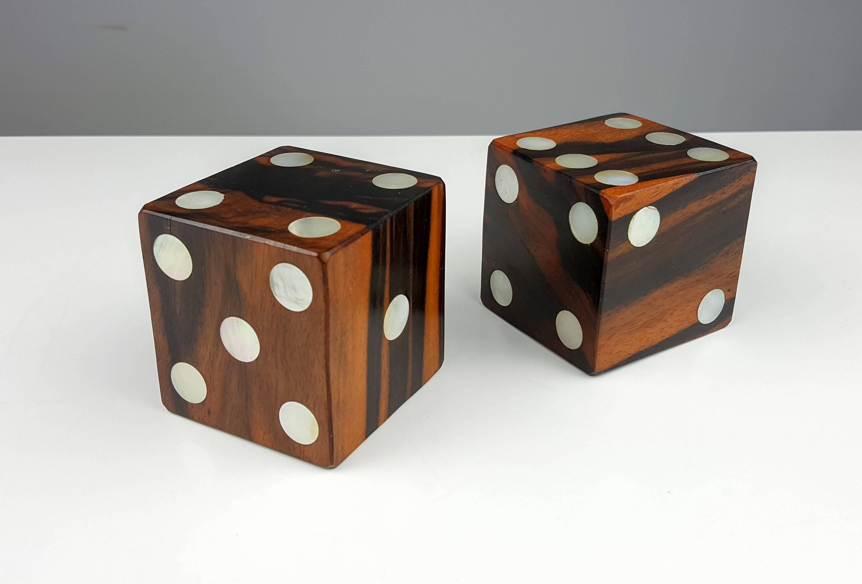 Very large exotic wood dice with inlaid mother-of-pearl. Made of solid blocks of what appears to be rosewood. Paperweight or bookends. Beautifully crafted with striking grain variations. 

We offer free regular deliveries to NYC and Philadelphia