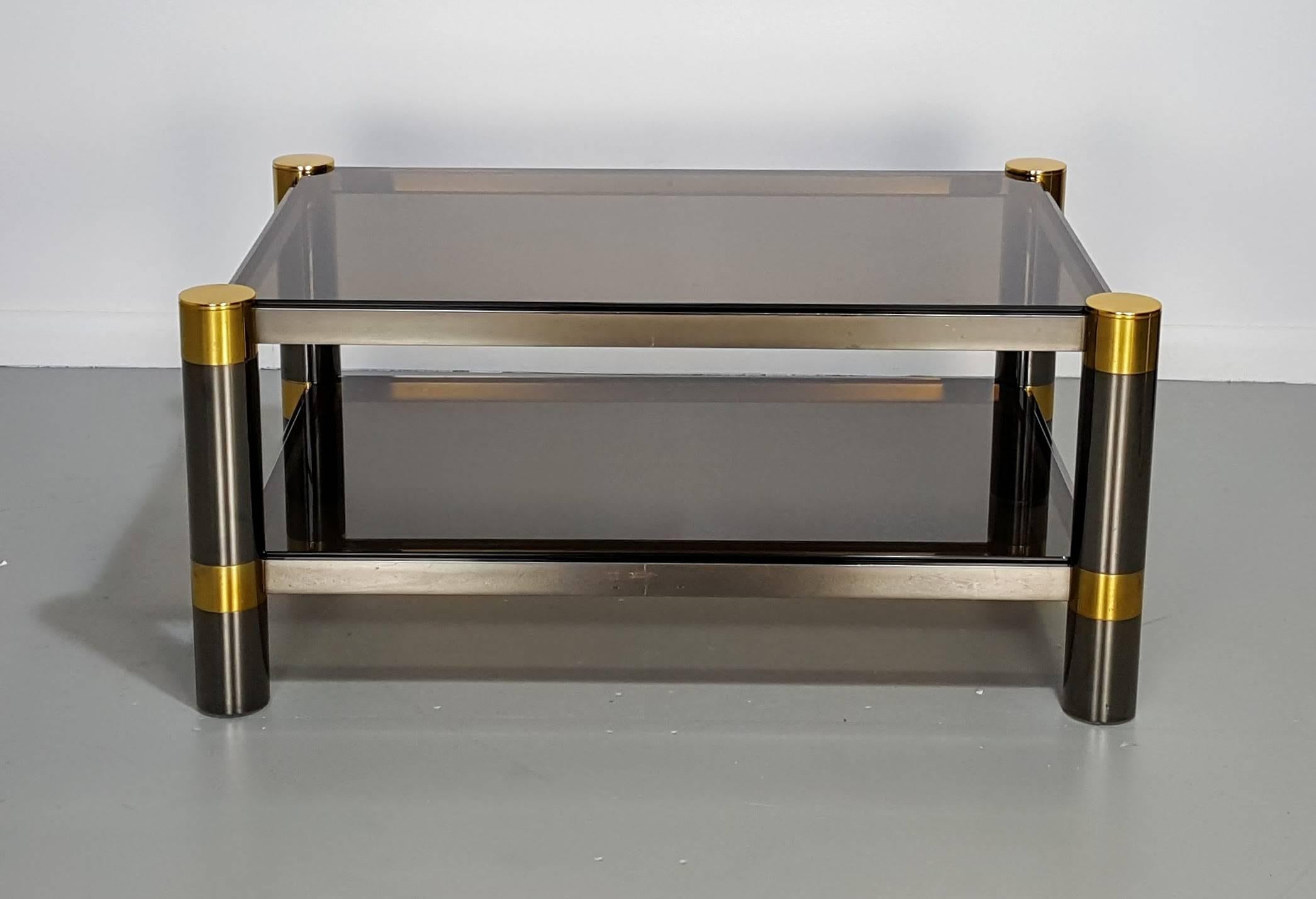 Karl Springer coffee table in rare gunmetal and gold tone finish, signed, 1970s. Glass has a smoked amber tint. Condition is excellent with less than average wear for age and use.

See this item in our private NYC showroom! Refine Limited is located