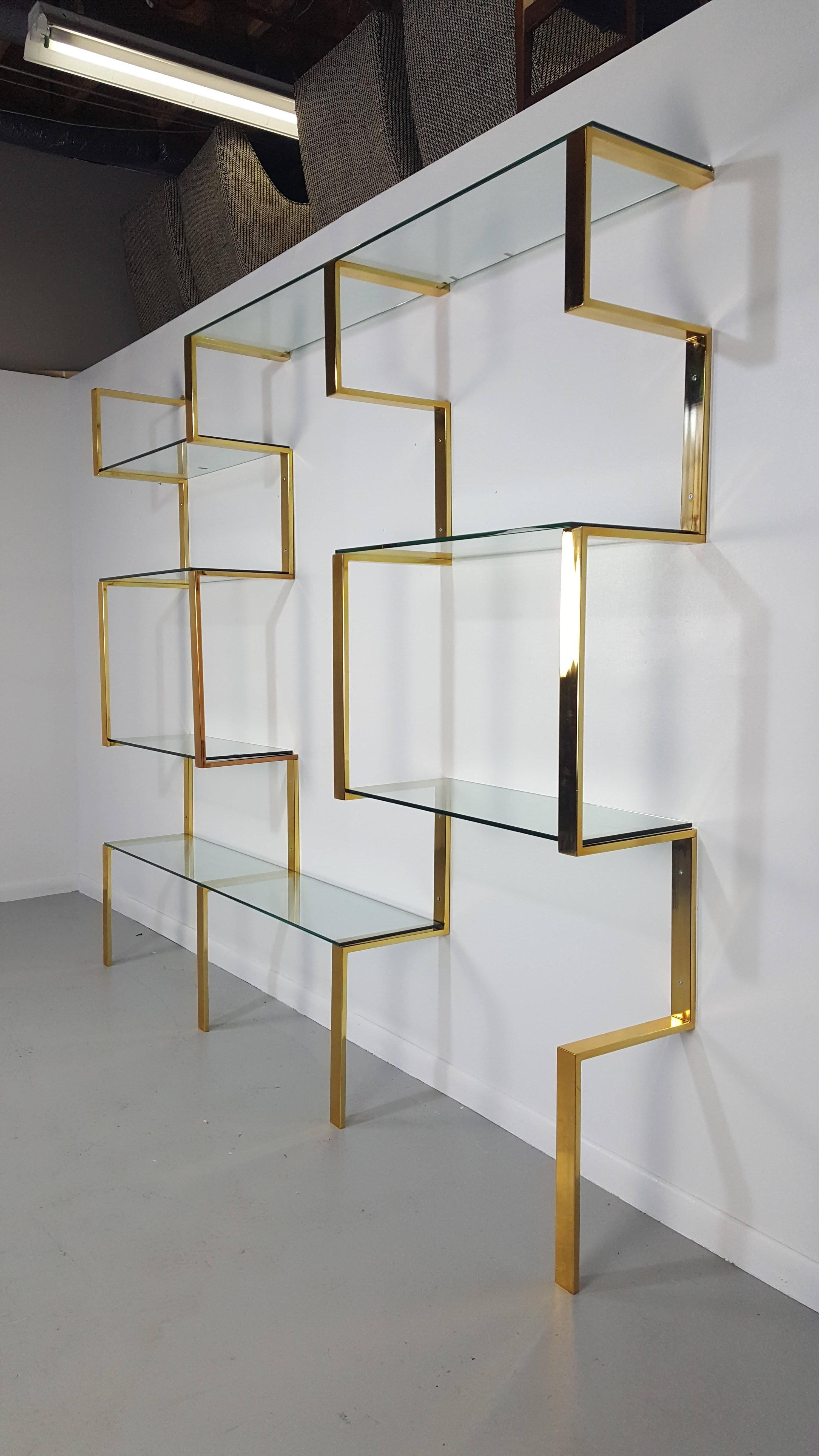 Architectural brass etagere shelving unit after Milo Baughman, 1970s. Wall mount system that can be adjusted to various widths to suite your space. Newly refinished in gold-toned brass.

We offer free regular deliveries to NYC and Philadelphia