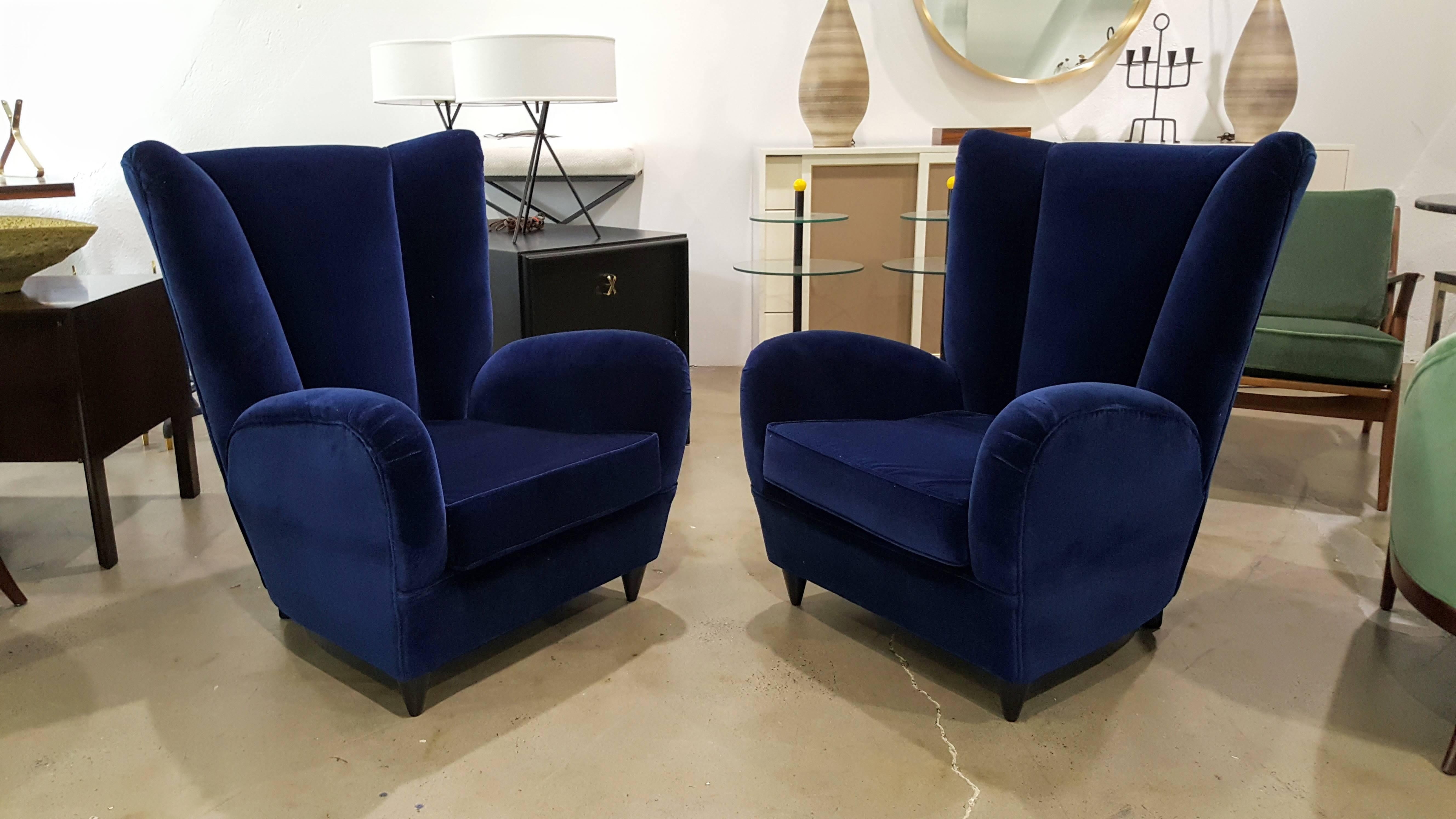 Pair of modern sculptural Italian lounge chairs after Paolo Buffa, Italy, 1950s. Newly upholstered in a vibrant royal blue velvet.

See this item in our private NYC showroom! Refine Limited is located in the heart of Chelsea at the history