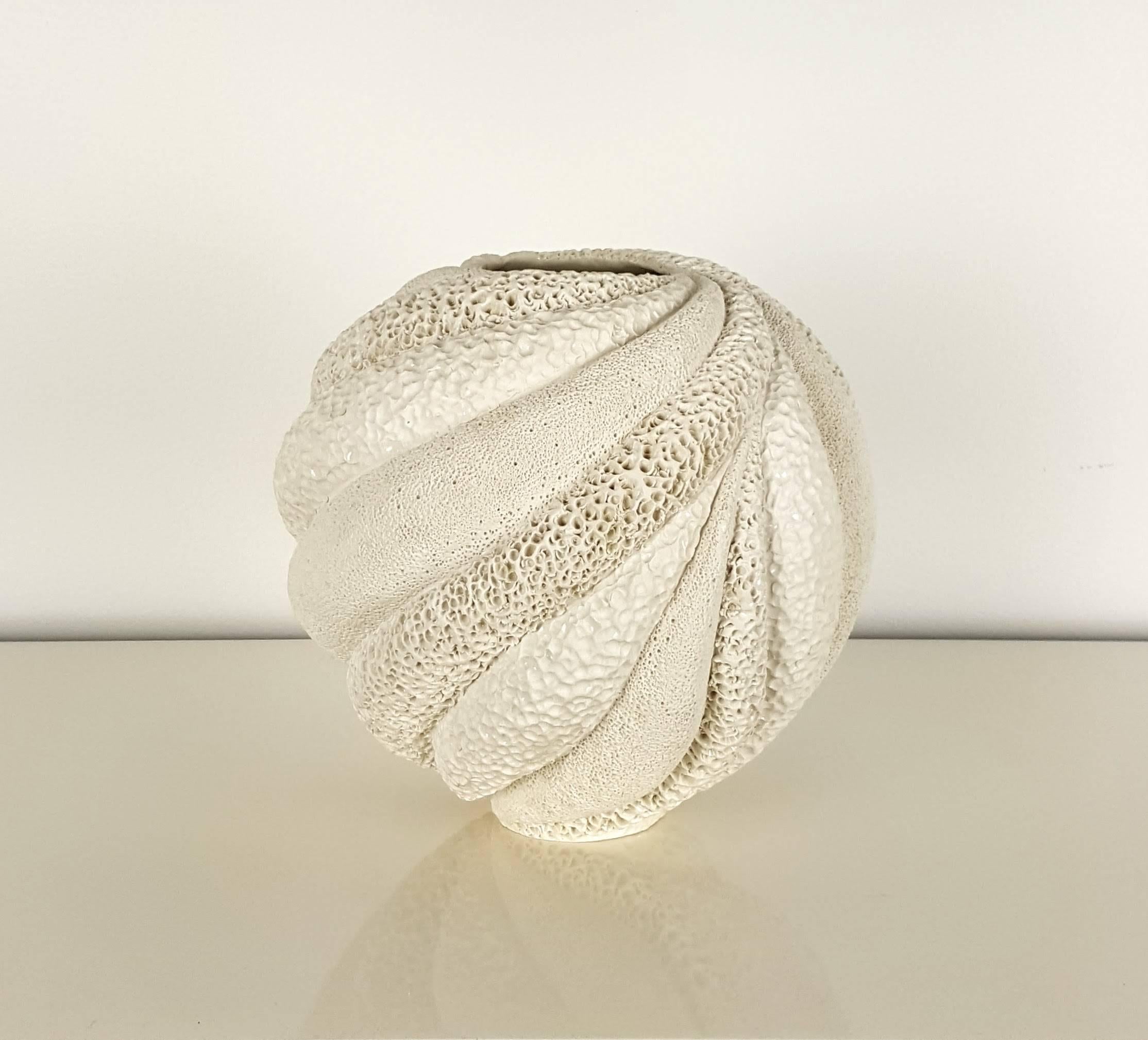 Creamy white medium round coastal collage vessel by Judi Tavill, 2016. Hand thrown. The carved pieces are created with thick walls, deeply carved, and painstakingly textured by hand. Pieces are coated with porcelain slip and further textured. After