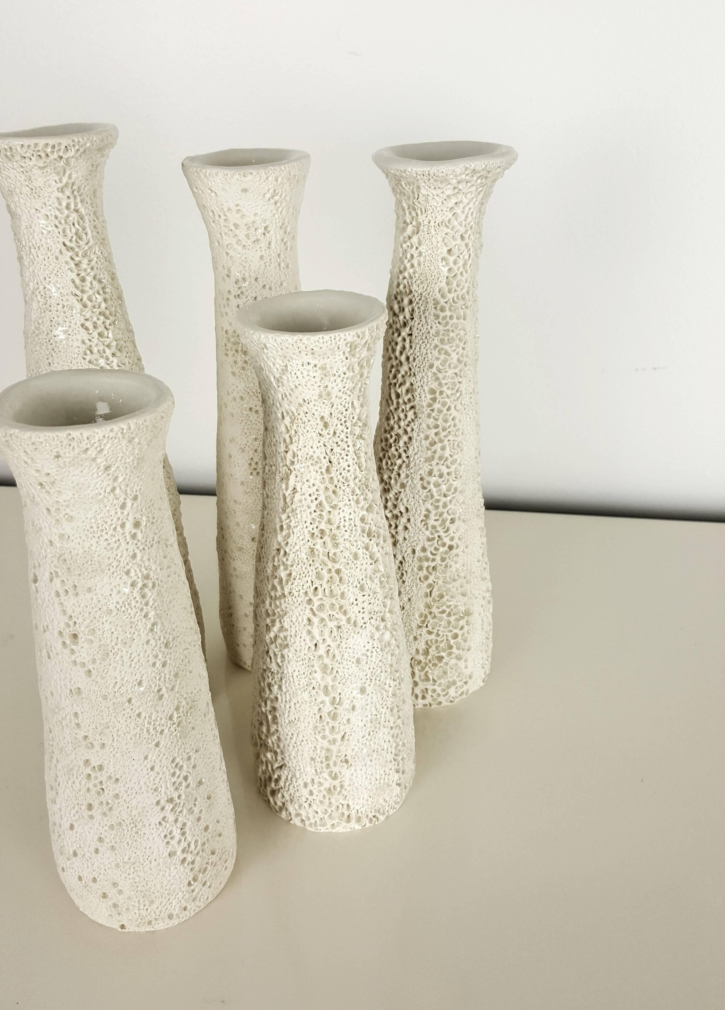 Grouping of candlesticks with applied organic coral texture by Judi Tavill, 2016. Graduated heights from 7.5" to 9.5".

About the artist:

Judi Tavill is a ceramic artist with a studio based on the oceanic shore of New Jersey. Born in 1968