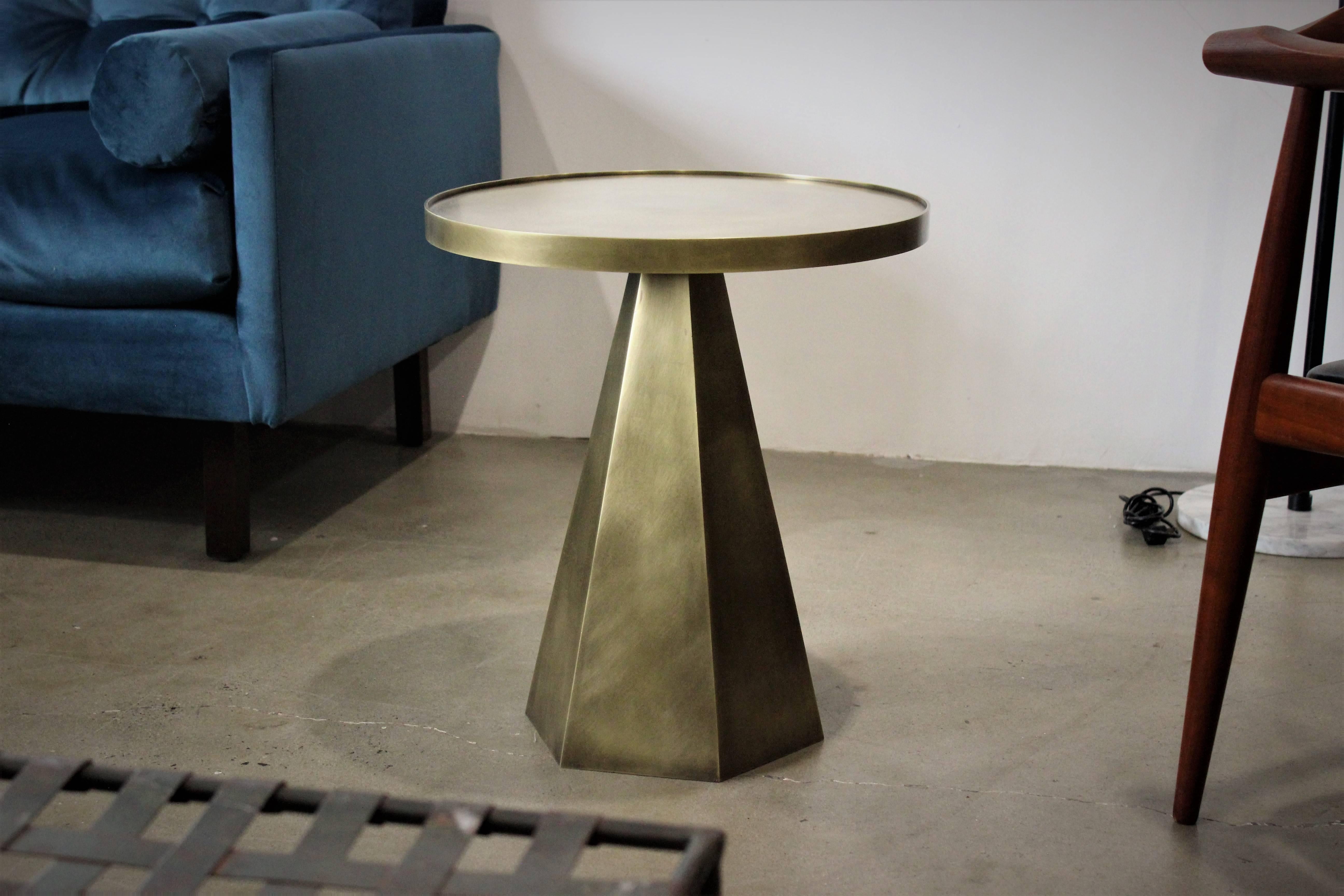 Architectural hexagonal side table in solid patinated brass. Handsome Brutalist, geometric design. This table is meticulously handcrafted in solid brass plate. The tapered base forged from six plates, each side brazed and ground to a crisp, clean