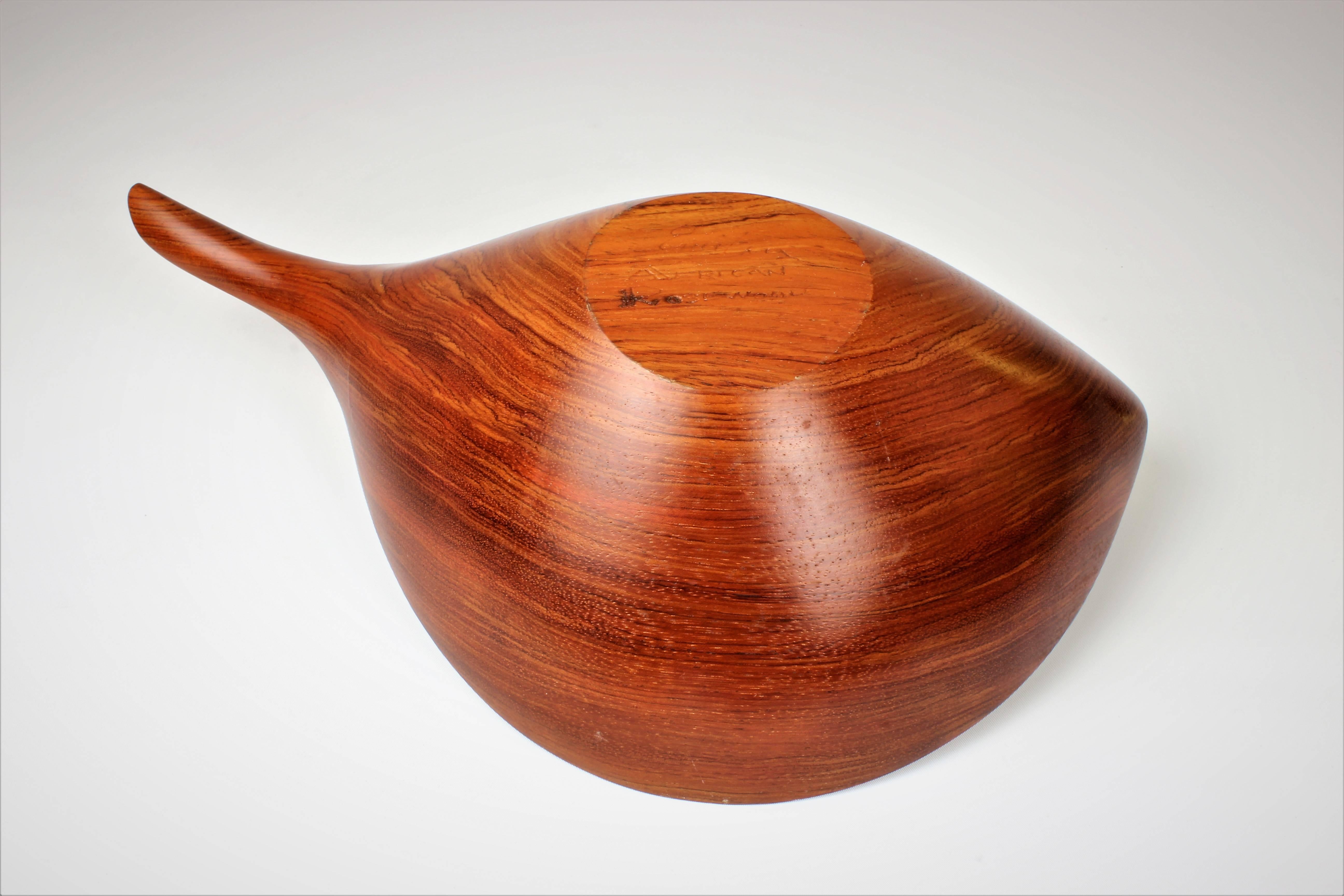 Large handmade decorative and functional turned bowl in African Rosewood by Emil Milan, 1970s. Grain is stunning and condition is perfect. 

Whether furnishing a contemporary Soho loft or stylish post-war Park Avenue penthouse, an artistic Central