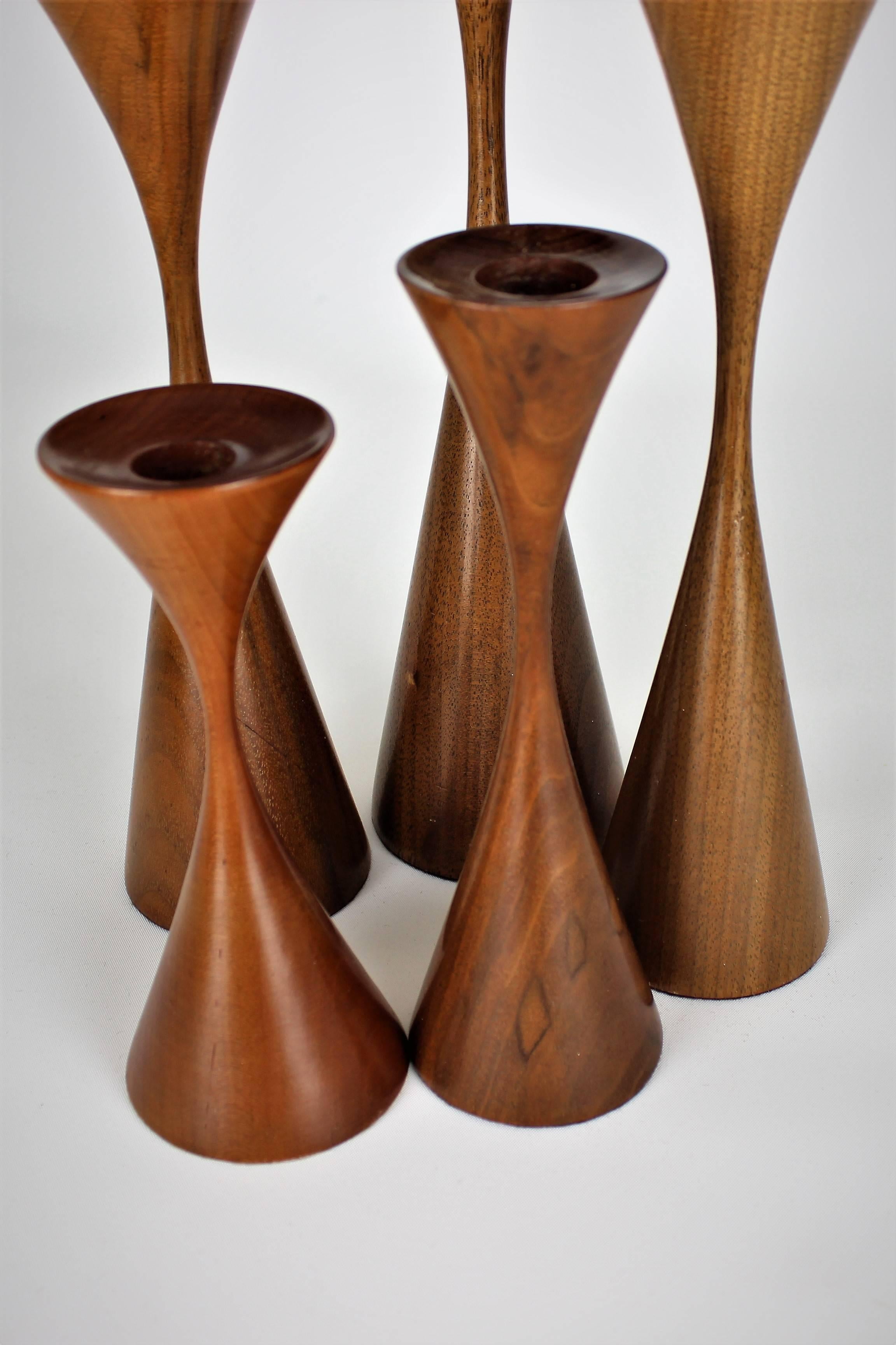 Grouping of five masterfully turned wood candlesticks by Rude Osolnik, 1970s. Height of these pieces range from 6" H to 12" H. This collection would make an excellent centrepiece or sculptural installation. Excellent condition. Osolnik was