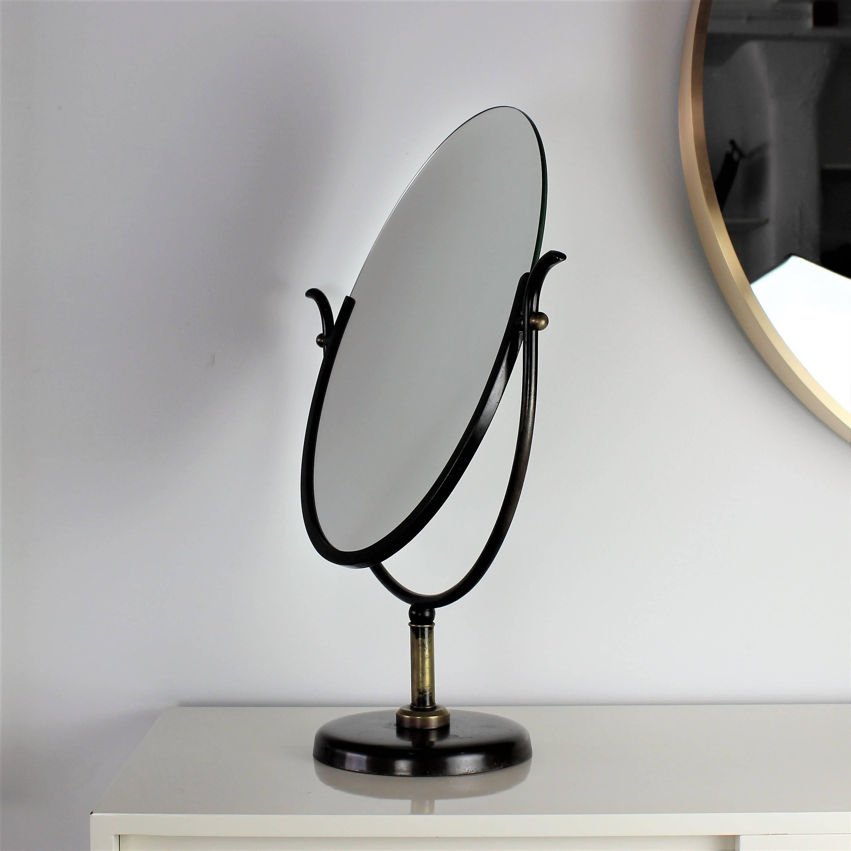 Large sculptural Charles Hollis Jones vanity mirror in bronze and brass, 1970s. Mirrored on both sides. Great vintage condition with minor wear shown in final image. The mirror itself has a light fog on some areas from age, but could be easily