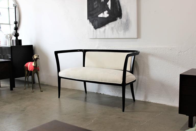 Sculptural and delicate open-arm settee or bench ebonized with white velvet, 1940s. Newly refinished and in excellent condition. Maker is unknown but has the Mid-Century Modern flair and characteristics of designers such as Ico Parisi, Gio Ponti,