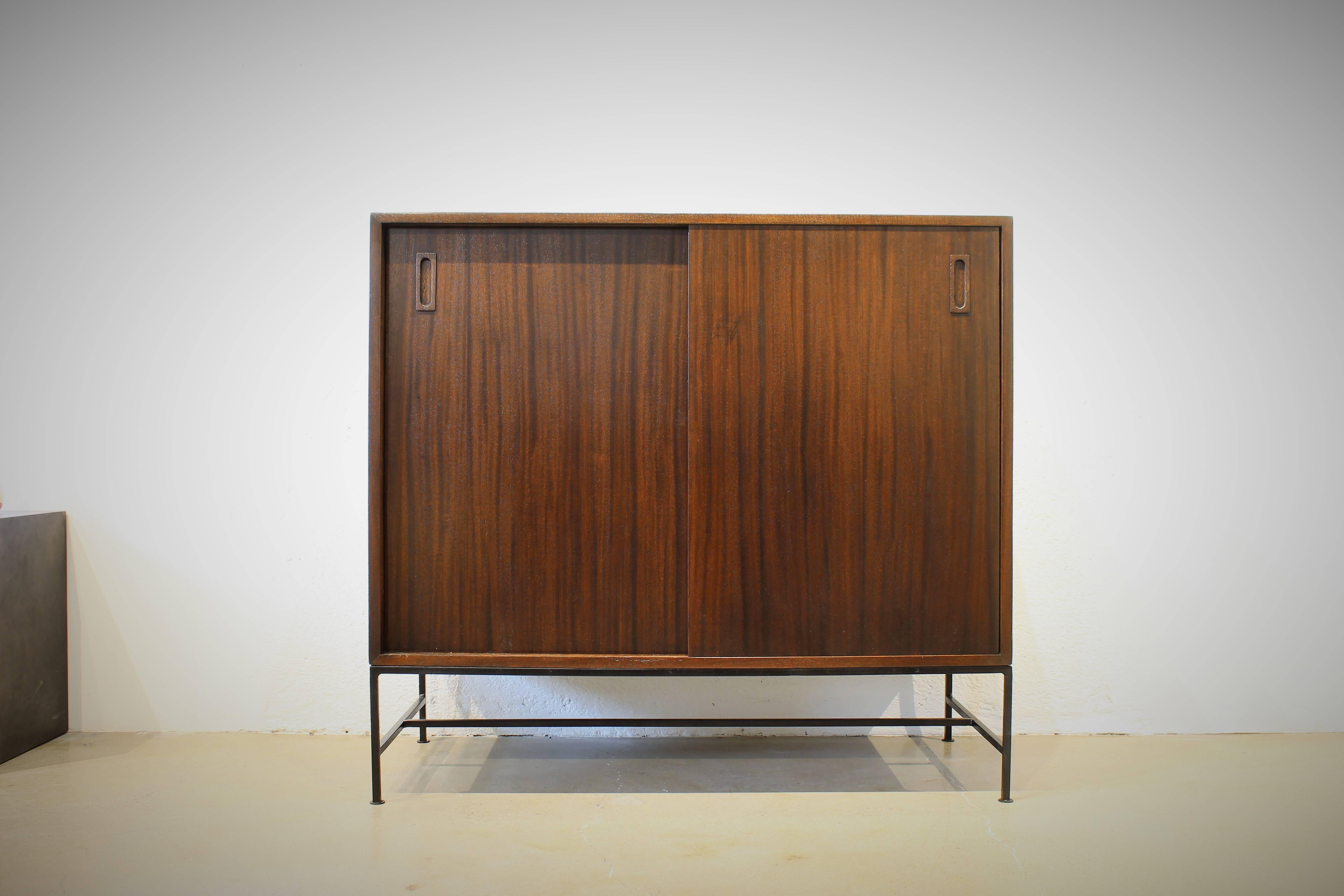 This early and rare chest by Harvey Probber is Classic modernism at it's best and highly functional! The sliding doors open to reveal white lacquered drawers on the left and open shelving on the right. It can be used as a gentleman's chest, a short