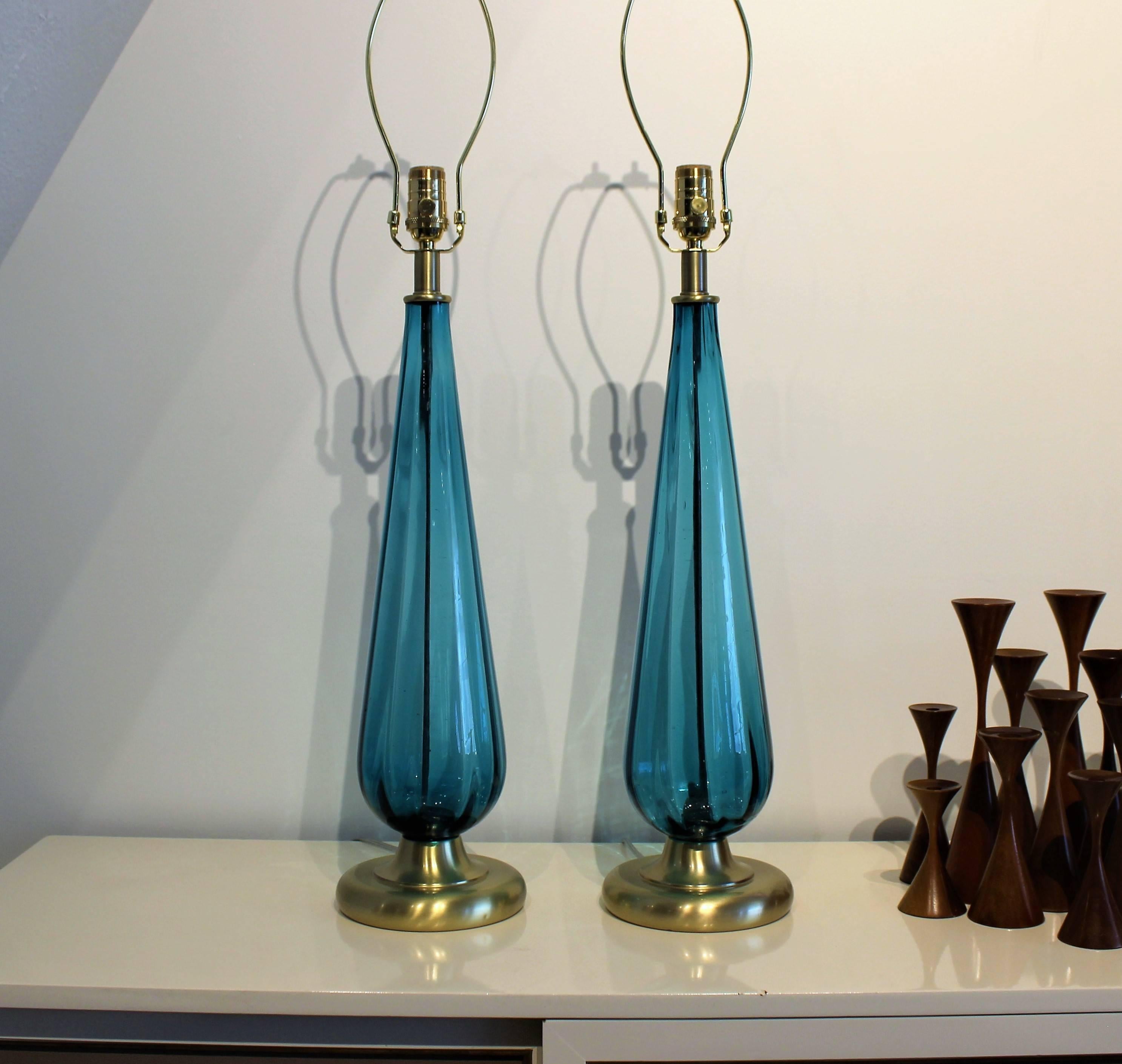 Large Murano glass lamps in cyan blue green, Italy 1960s. Handblown glass lamp bodies in excellent condition, free of chips or cracks. Brass hardware and bases have been refinished. 