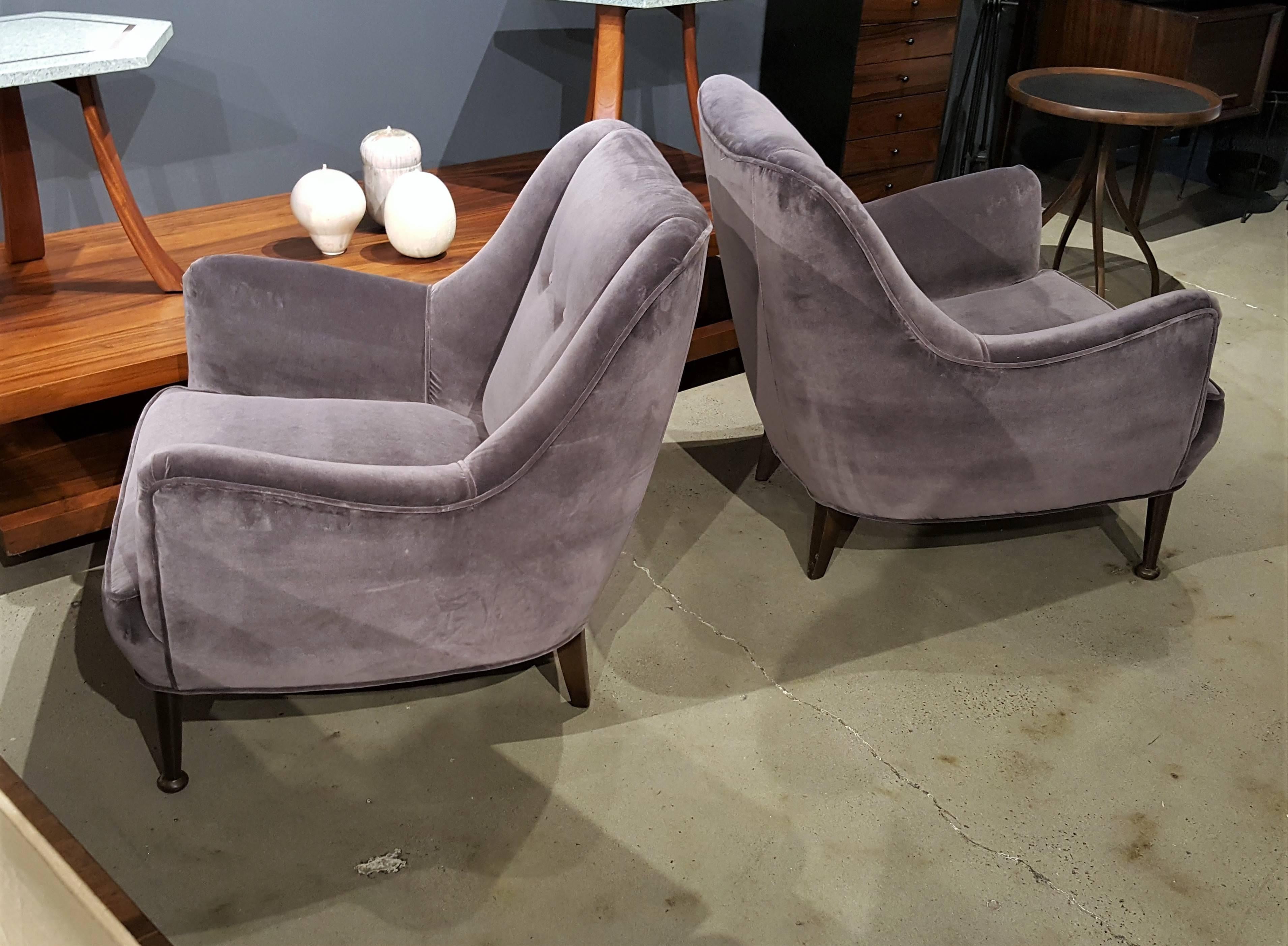 Pair of gorgeous Mid-Century Modern lounge chairs in deep gray lilac cotton velvet with sculptural walnut legs. Very comfortable and well made with Classic lines that work well in nearly any interior design scheme. The origin is unknown but they