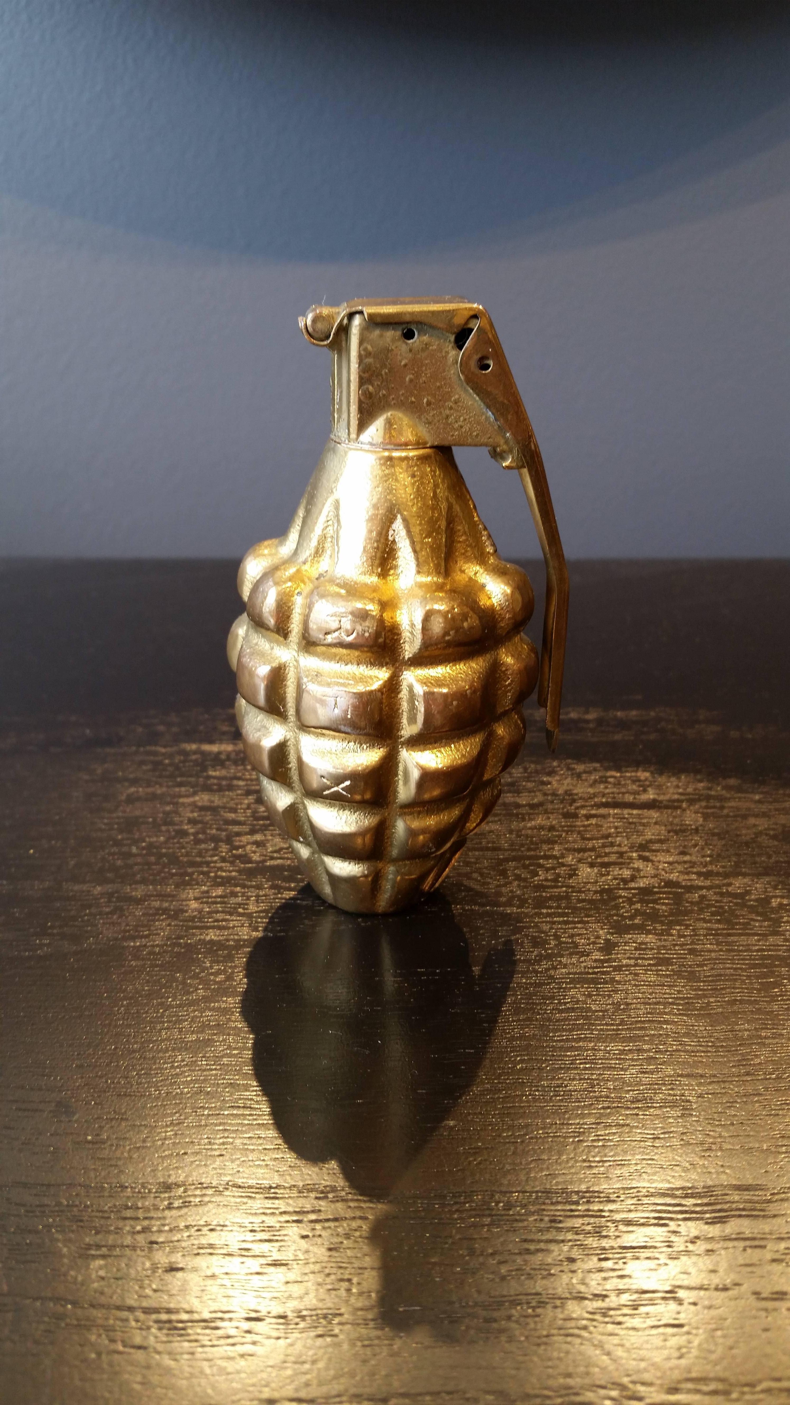 Fantastic conversation piece real grenade with brass plating. Perfect paperweight or table sculpture--we love it atop a stack of books. In very good condition. 

Whether furnishing a contemporary Soho loft or stylish post-war Park Avenue