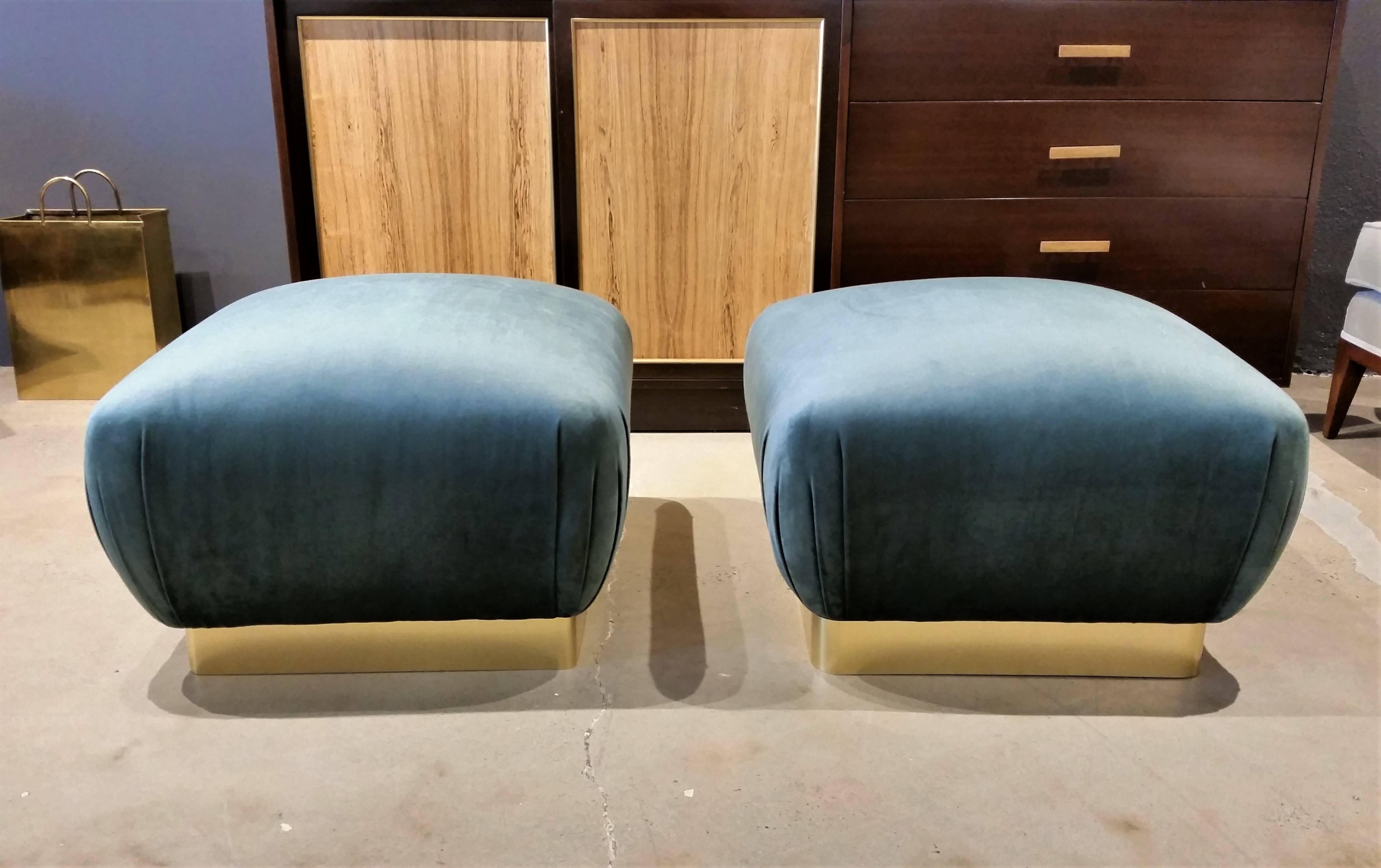 Stunningly glam pair of souffle poufs in the style of Karl Springer, 1970s. Completely restored with new brass wrapped bases and plush blue green velvet upholstery. Incredible accent pieces work well as seating or as ottomans or benches. 

Whether