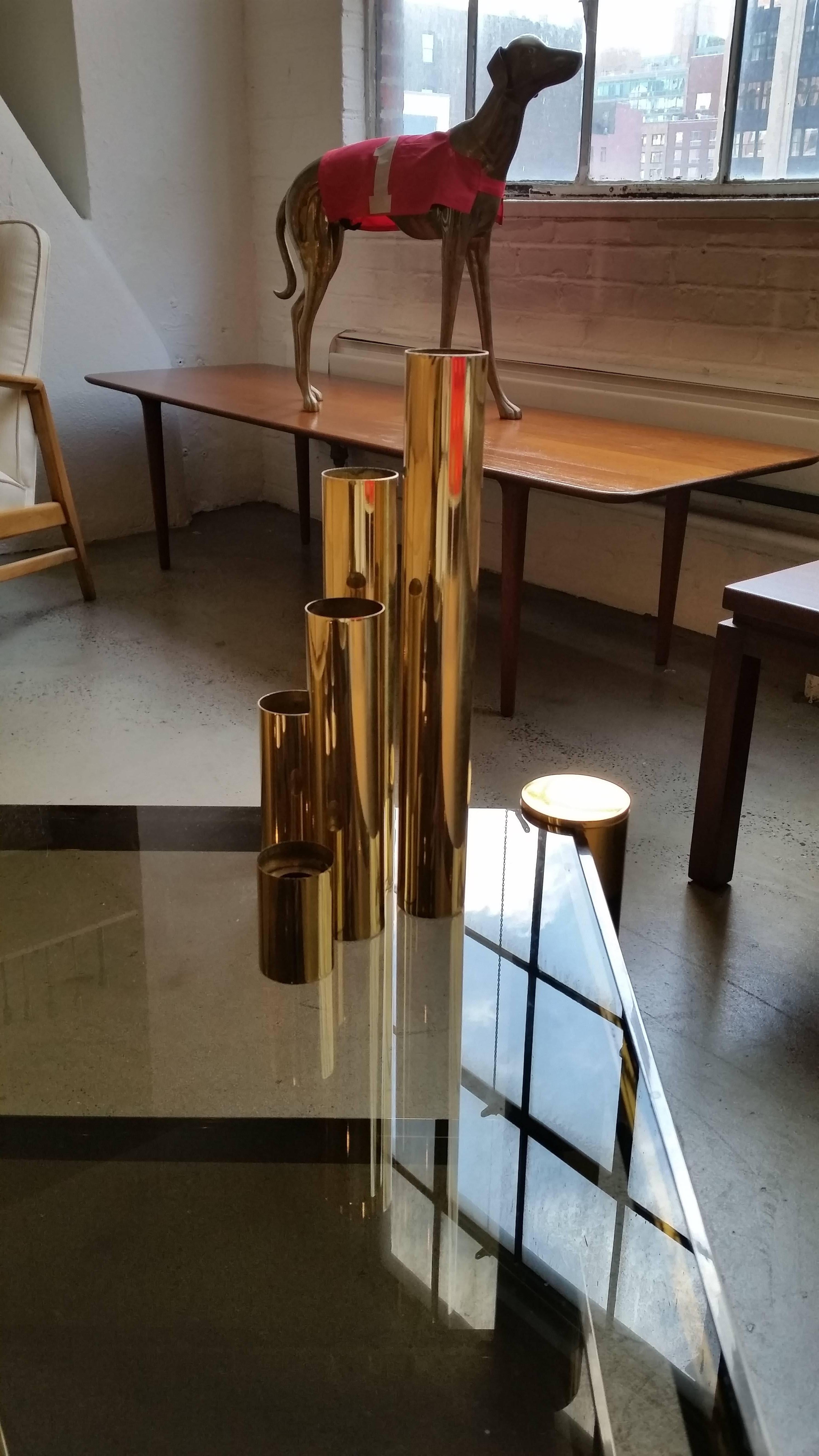 Set of five 1970s glam tubular brass candleholders in graduated heights. These have been recently re-plated and are in excellent condition. Heavy, substantial pieces--would function well as a candelabra. Maker unknown. Taper candles not included.