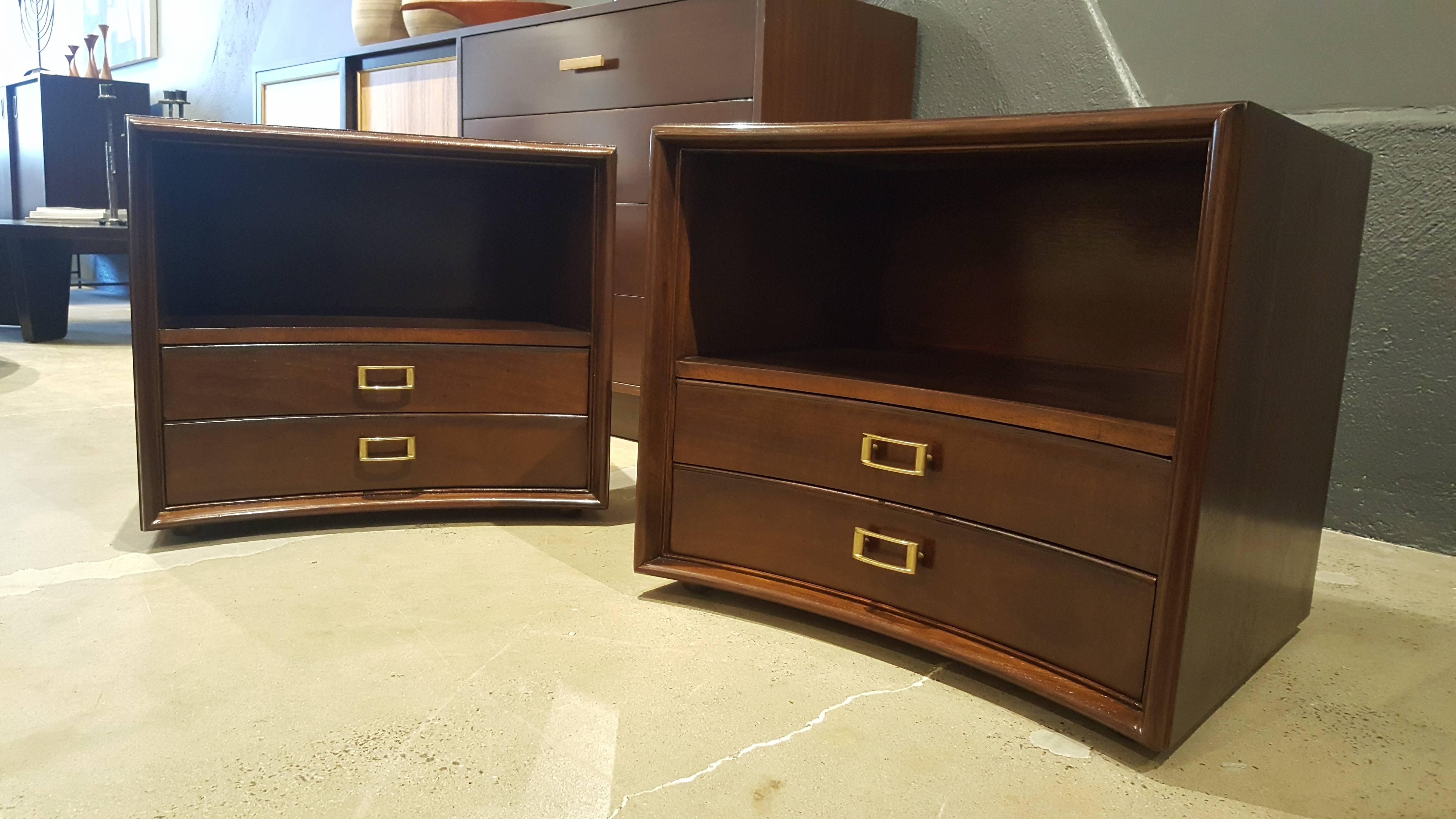 Handsome, classic pair of nightstands by Paul Frankl for Johnson Furniture, late 1950s-early 1960s. Curved fronts and sculptural hardware with great storage. These appear to float, as they sit on small bun feet. Scaled nicely for vintage or current