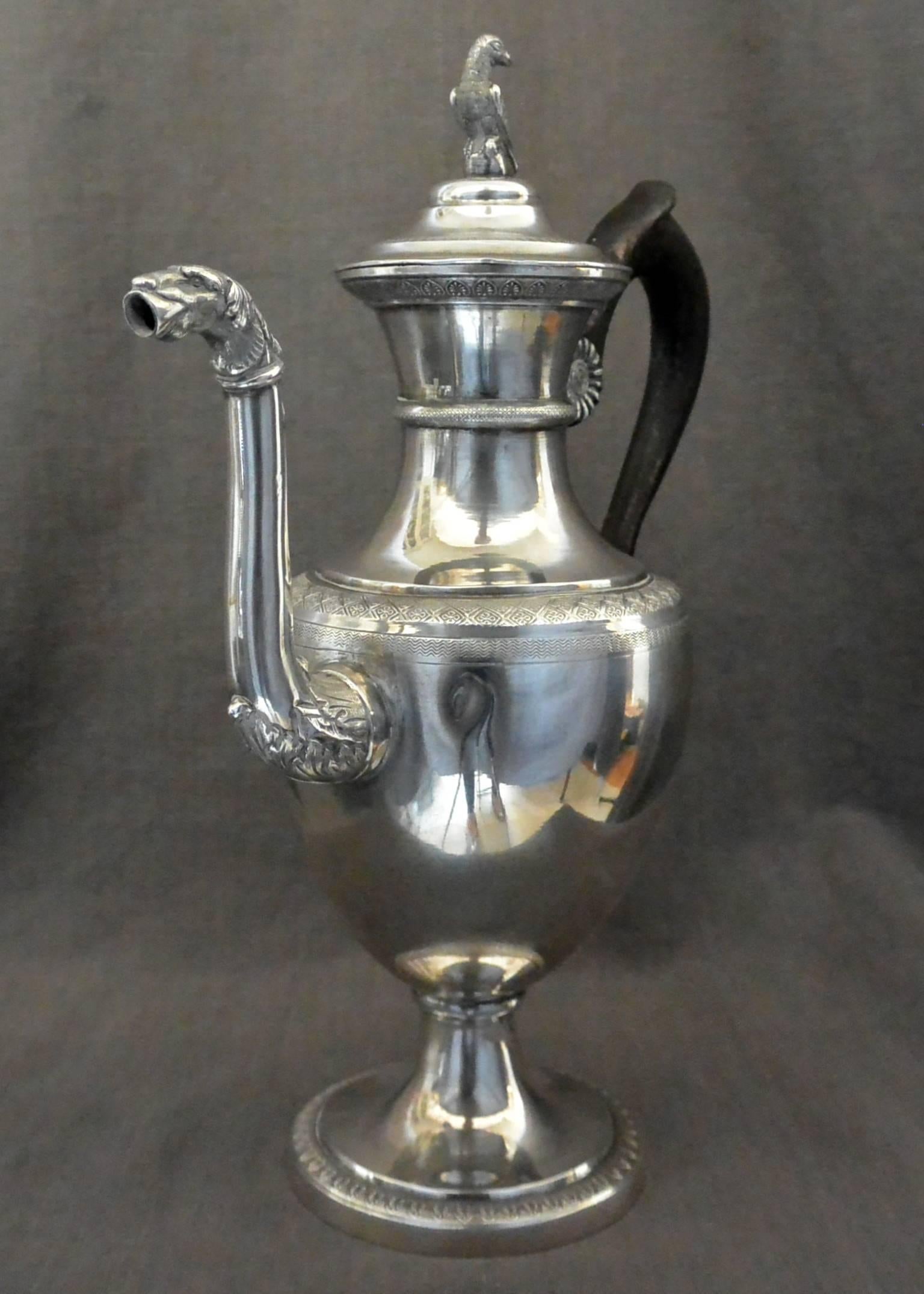 Italian Neoclassical Silver Coffee Pot. Neapolitan caffettiera in sterling silver with wood handle of neoclassical form and decoration with parrot lid and canine spout; with Italian sterling hallmarks, Italy, early 1800s.
Dimension: Handle to spout
