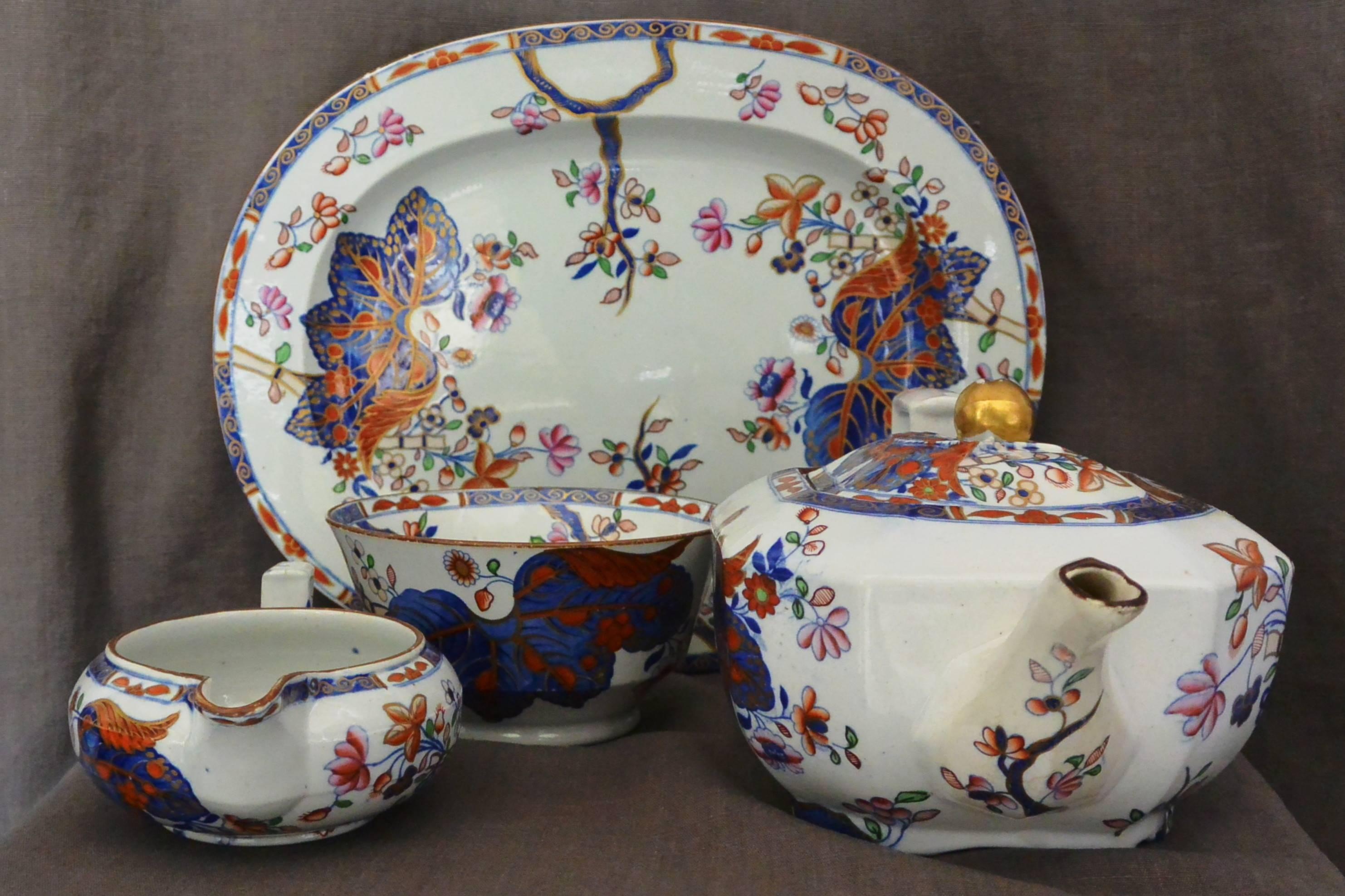 Antique Copeland Spode tobacco leaf or cabbage leaf tea pot, cookie platter, creamer and sugar bowl in blue, red, peach, pink and green with gilt highlighting. Markings for Spode in underglaze blue and pattern 2061 in underglaze red.
Dimension:
1.