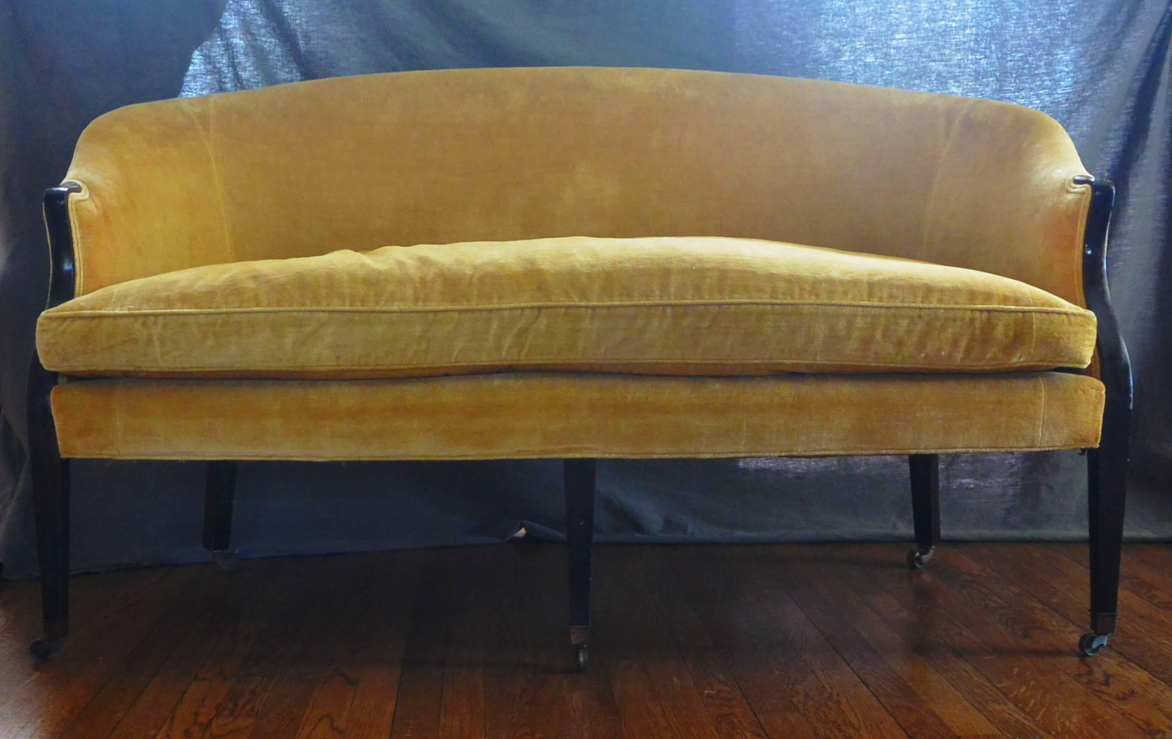 George III period linen velvet sofa. Versatile simple serpentine mahogany framed George III period sofa on five tapered legs on brass casters. Later vintage upholstery in butter gold linen velvet, England, circa 1790.
Dimension: 61.5