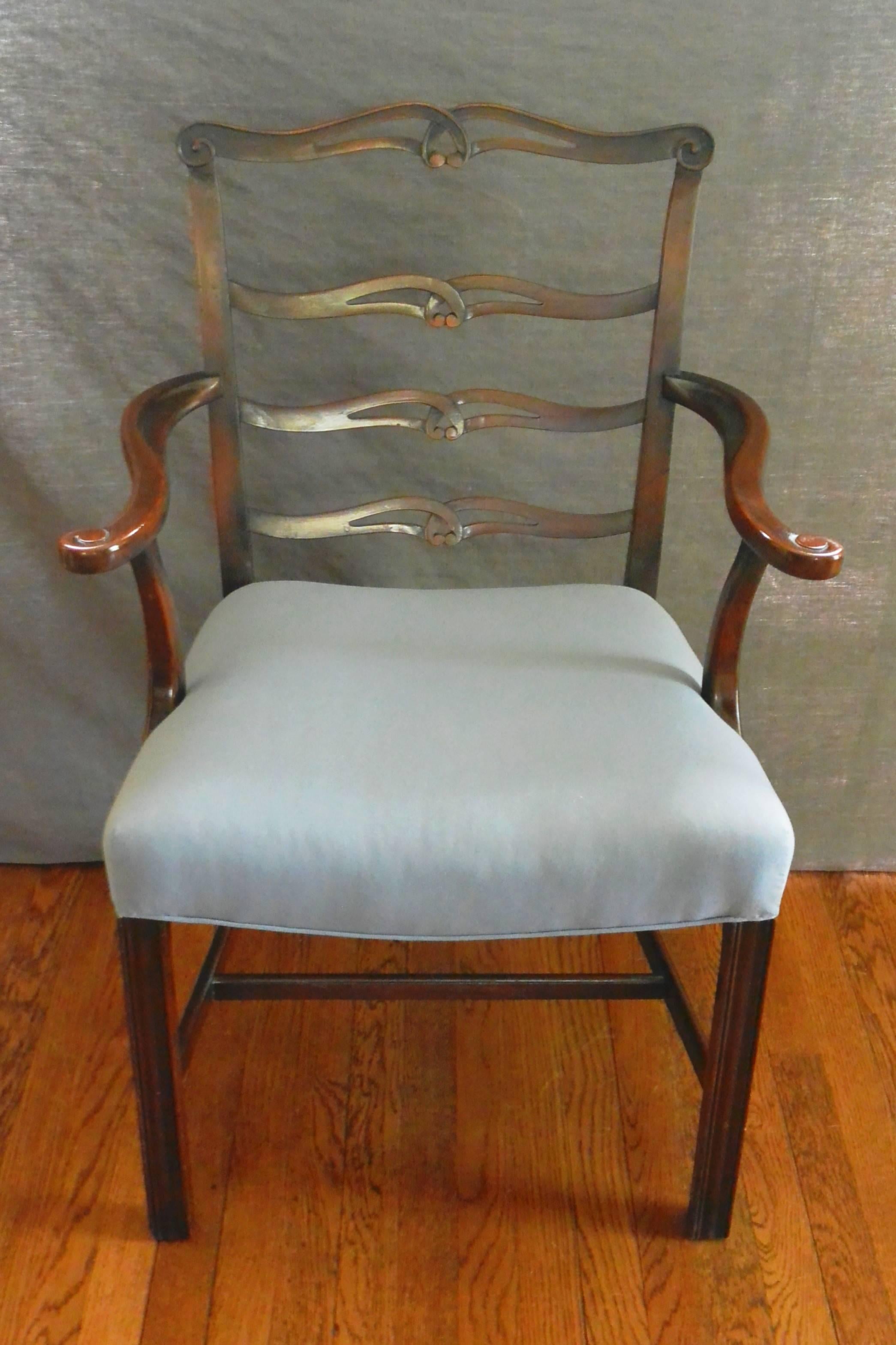 George III style ladderback armchair.  Chippendale form mahogany armchair with four shaped and pierced splats and moulded front legs below newly upholstered seat.  England, early 19th century.   
Dimensions:  27" W x 21" D x 36.25"H;