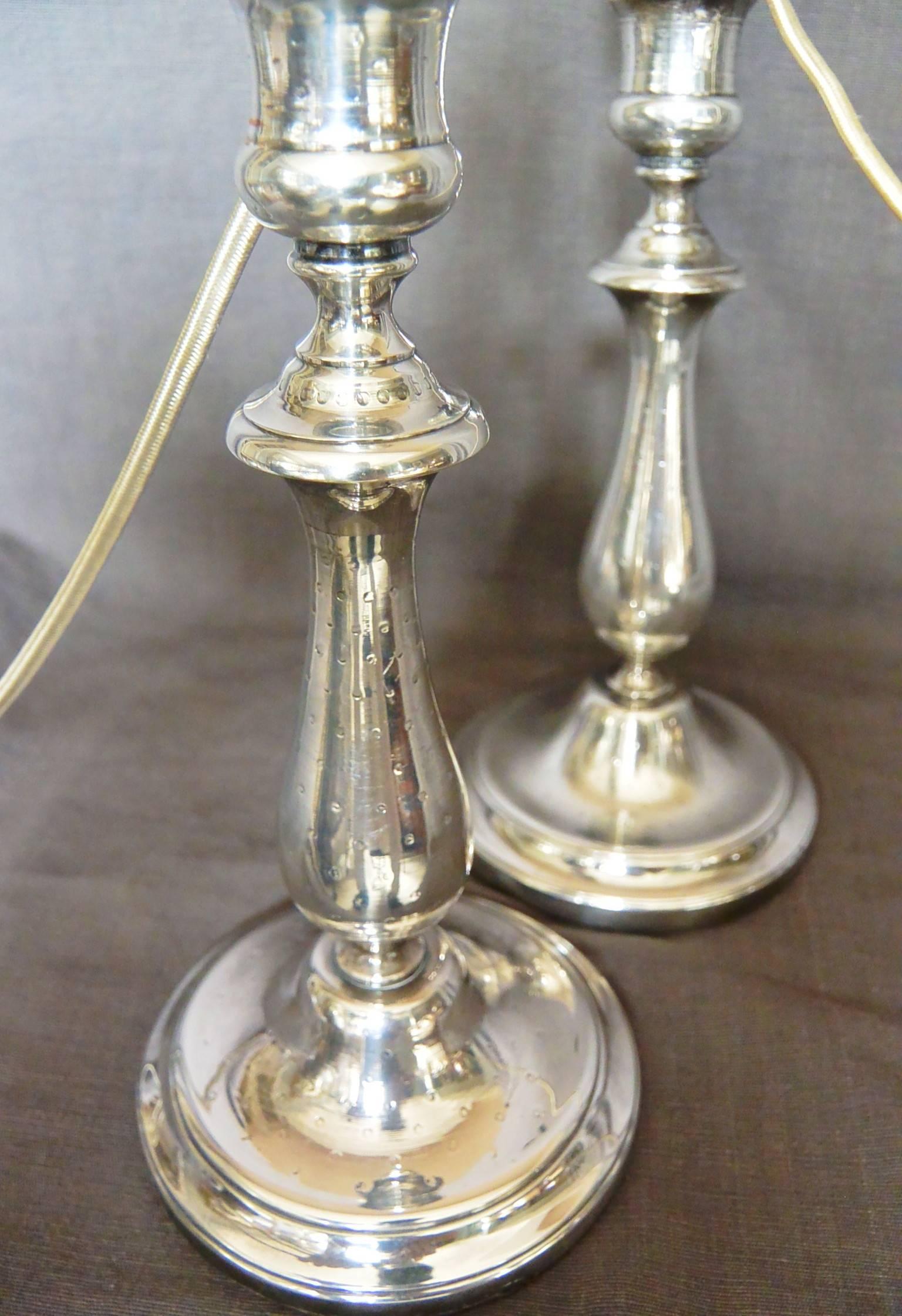 Pair Christofle silver candlestick lamps. Vintage Christofle boudoir/dressing table or dining table lamps in a subtle dot or strawberry seed pattern. Newly electrified with silver silk cord and switches. With hallmarks for Christofle. France, late