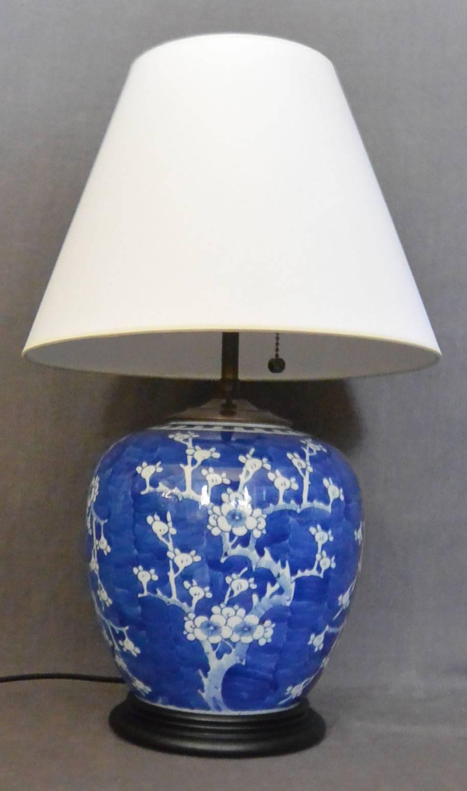 Rich blue and white cherry blossom ginger jar mounted as a lamp. Newly electrified with black silk cord and switch, China, 19th century. 
Dimension: 8" diameter x 9" to base of stem; diameter base 6.5" and 20" H to