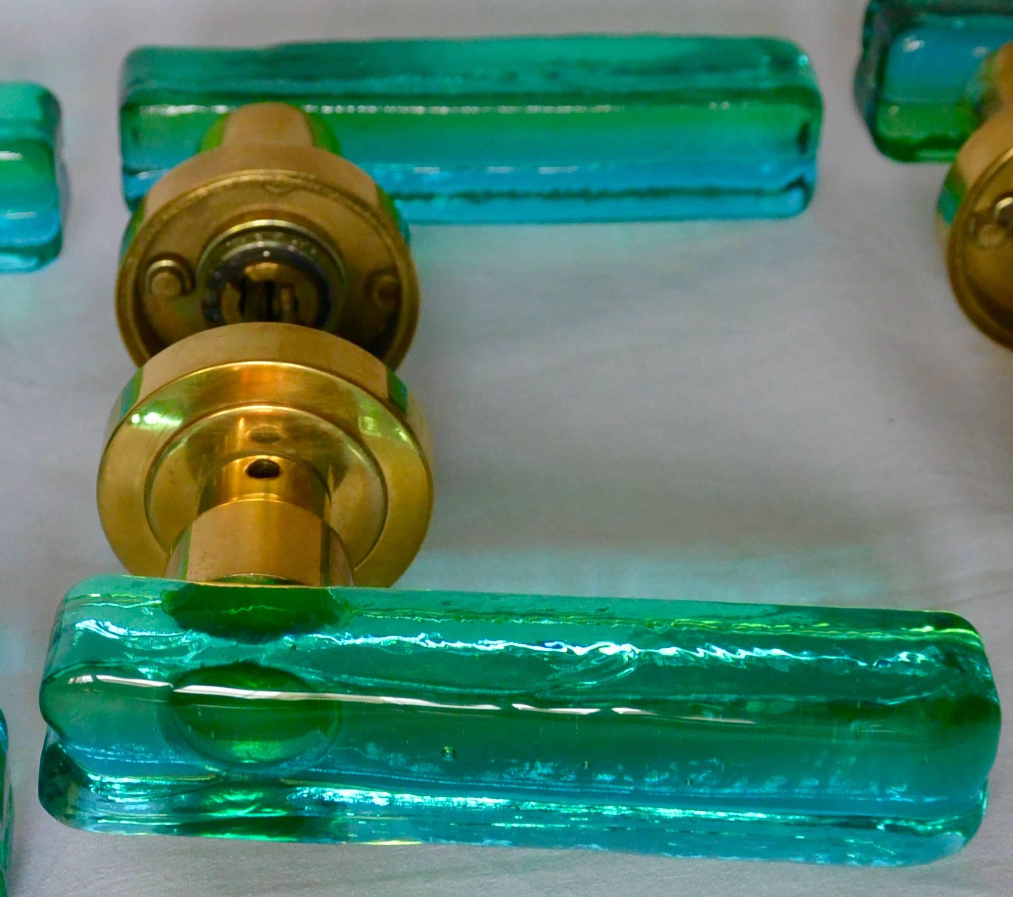 Set of seven Murano green and blue glass door handles.  Vintage mid-century modern beautiful Murano glass handles with brass hardware; can be combined as three pair and one single or seven single lever handles, Italy, late 1960s to early