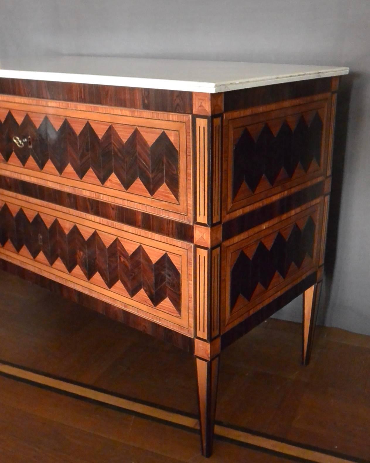 Italian Louis XVI period chest of drawers in modern and bold geometric ebony marquetry inlay with white marble top; newly restored. Naples, late 18th century. 
Dimensions: 50.25