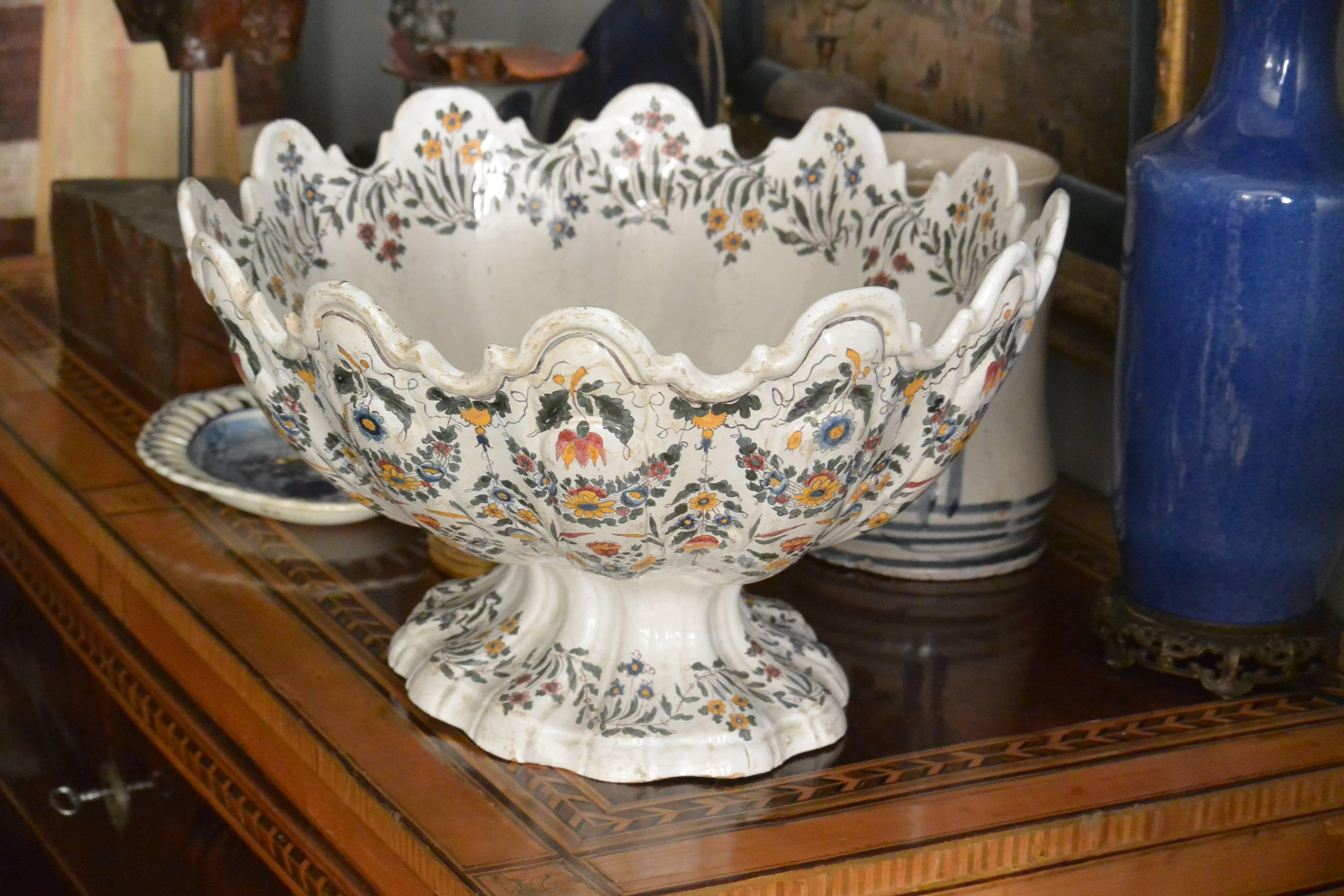 Very large Bassano centerpiece bowl of footed monteith form. Decorative floral sprays and swags throughout the twelve lobes and footed base as well as large bouquet on interior. Underglaze blue marks for Bassano. Italy, circa 1840.
Dimensions: 18