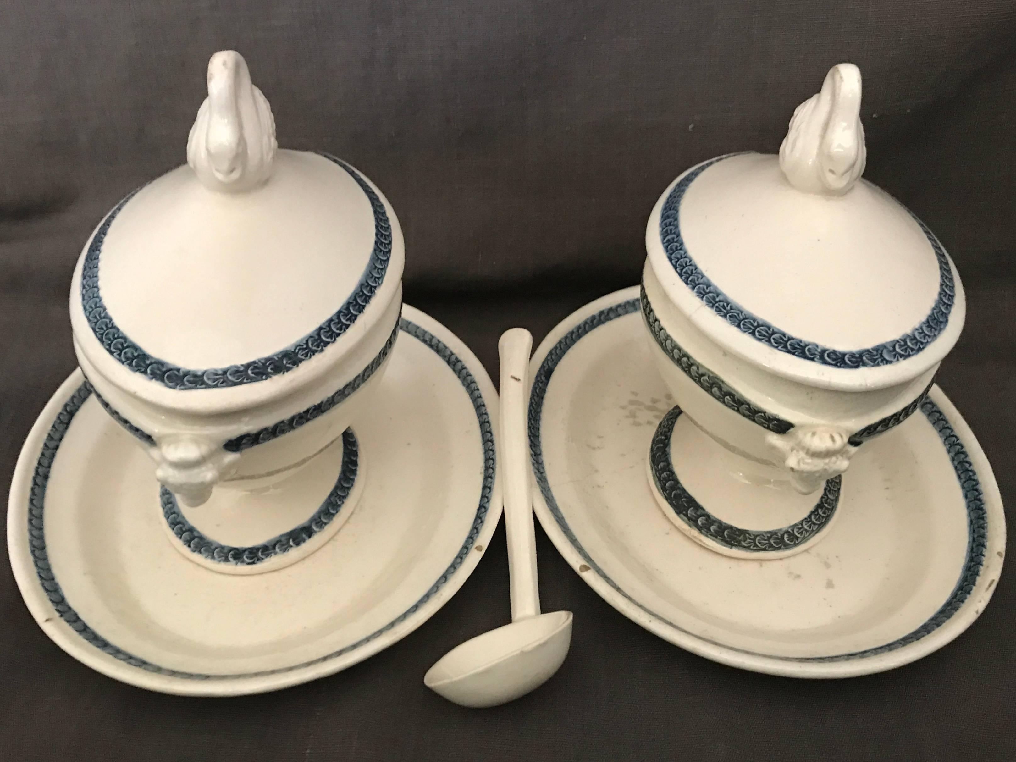 Pair blue and white swan sauce boats. . Neoclassical cream-ware lidded sauce boats with under-plates and original ladle, all with blue and white borders, bovine head handles and swan handled lids. Early Giustiniani manufacture. Italy, circa