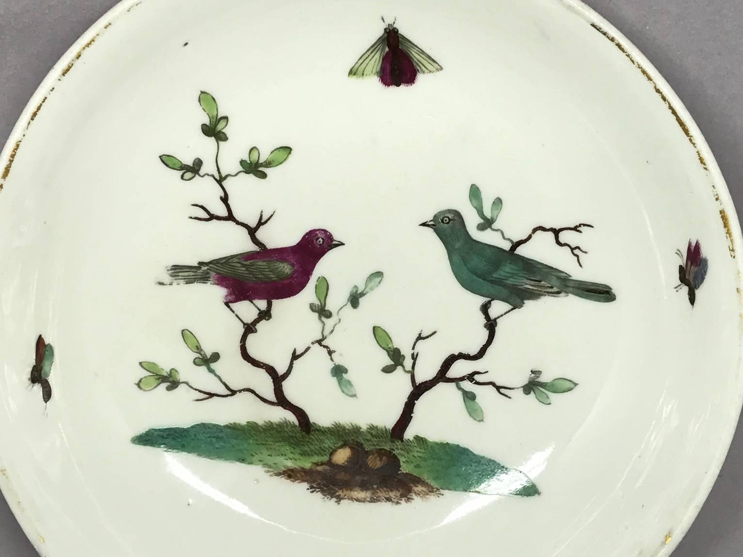 Small bird plate. Hand-painted small dish / vide-poche with birds and insects in a landscape with soft gold rim. Underglaze blue crown marks for Ludwigsburg. Germany, late 18th century.
Dimensions: 5.25