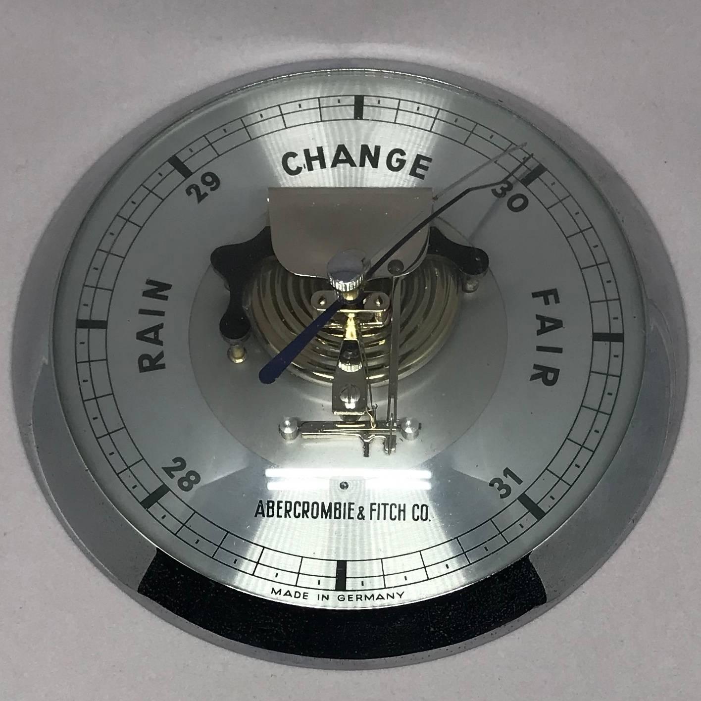 Midcentury Abercrombie and Fitch decorative barometer. Chrome and glass decorative barometer in a very clean midcentury style. 
Dimensions: 6.25