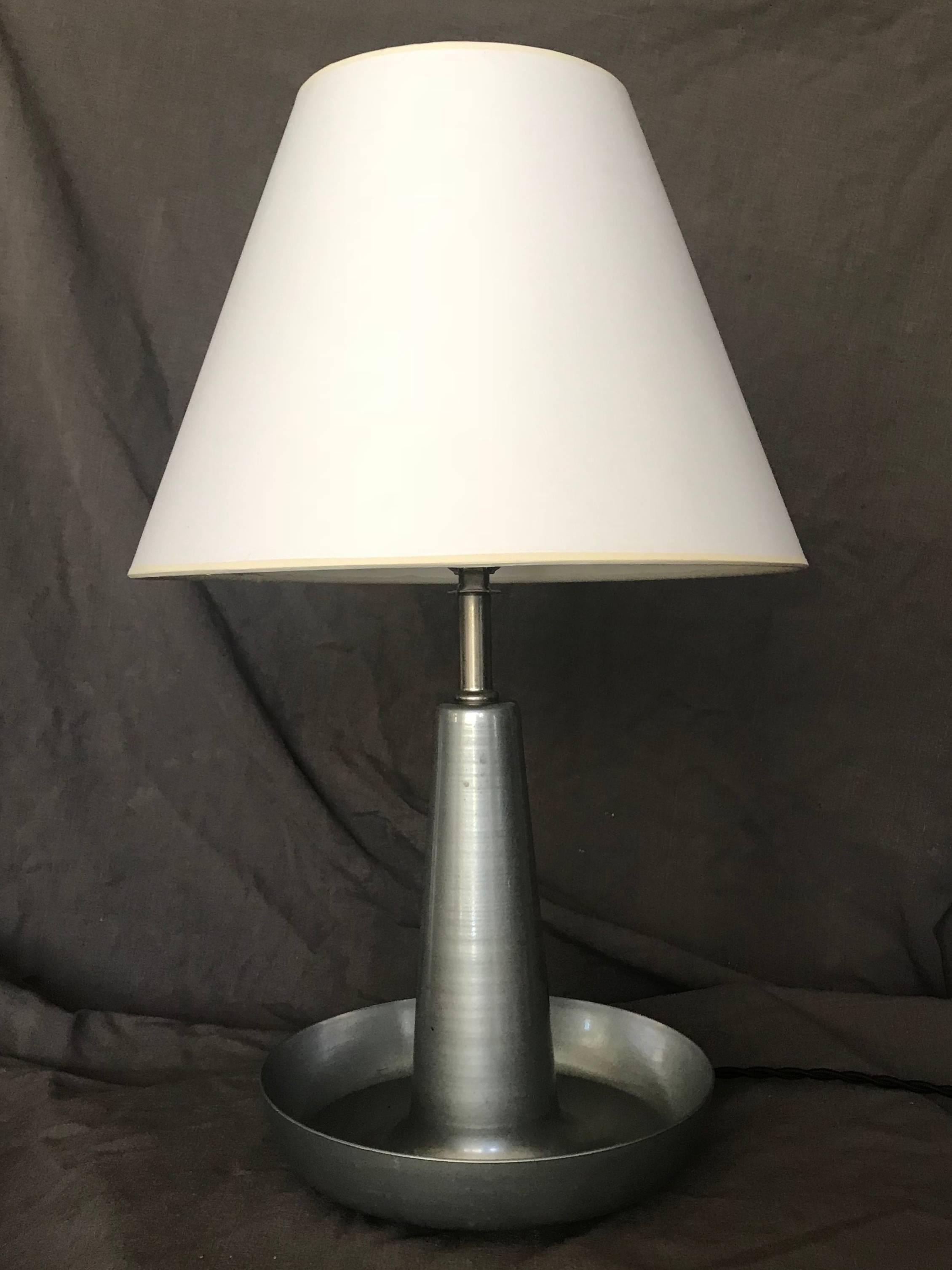 Pair of mid-century aluminum lamps. Pair sleek, quiet modern lamps in aluminum newly rewired with black silk cords and switches. American, late 1960s lampshades are optional and not included. 
Dimensions: bowl 8.5