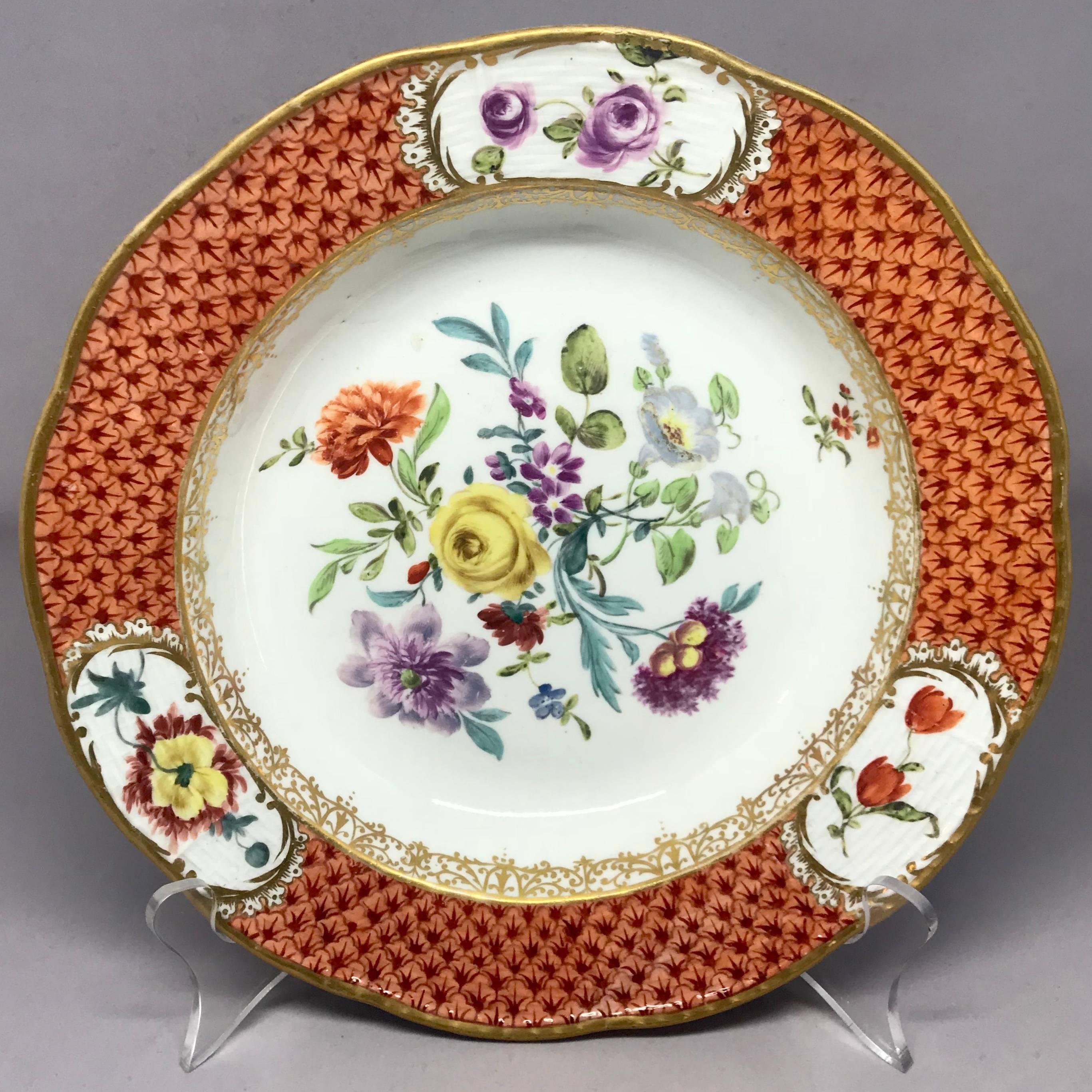 Meissen gilded iron red floral plate. Unusual Meissen soup plate with decorated border with three reserves of different blooms surrounding large central bouquet; of irregular fired form with undulating rim, yet decorated and in perfect condition.