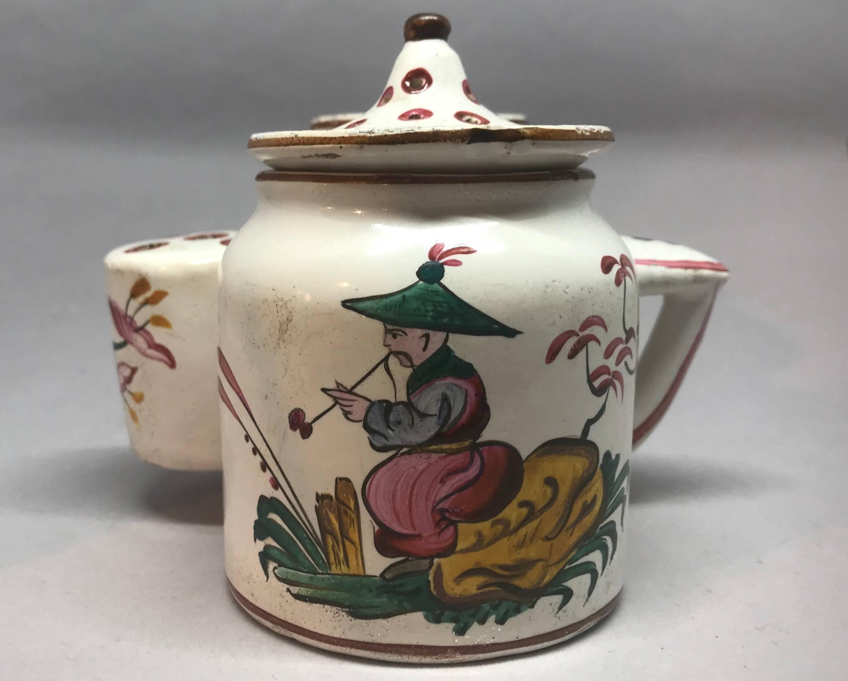 Strasbourg chinoiserie inkwell. Antique double-pot faience handled encrier with quill pot and removeable ink pot and cover and sand pot, both with pagoda-top finials, all painted with chinoiserie figures and floral sprays. France, late 18th century.