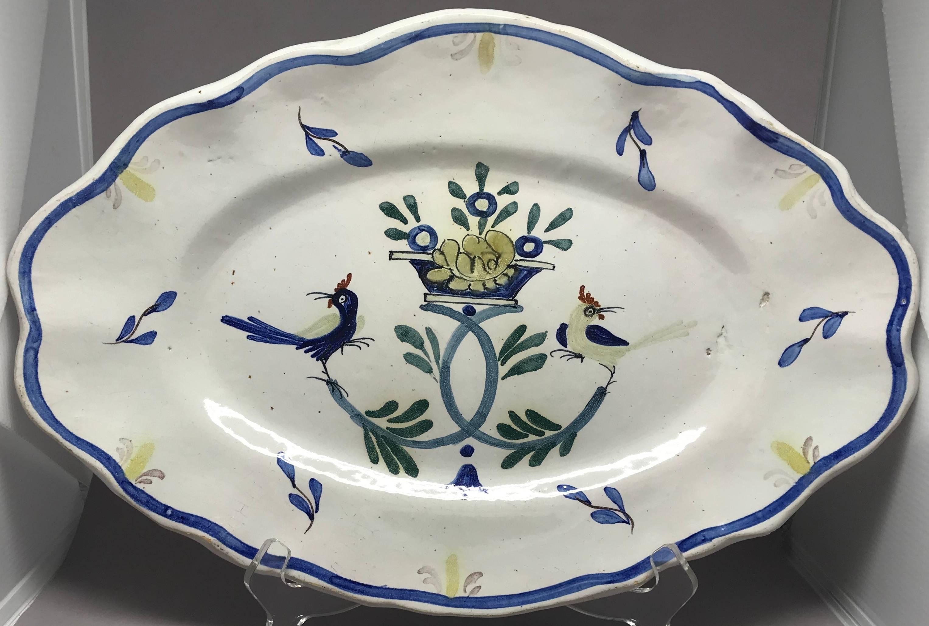 French Faience Bird Platter.  Hand painted scallop edge oval platter in French Country design with flowers and roosters and rich French blue banding.  France, nineteenth century.  
Dimensions: 14.5
