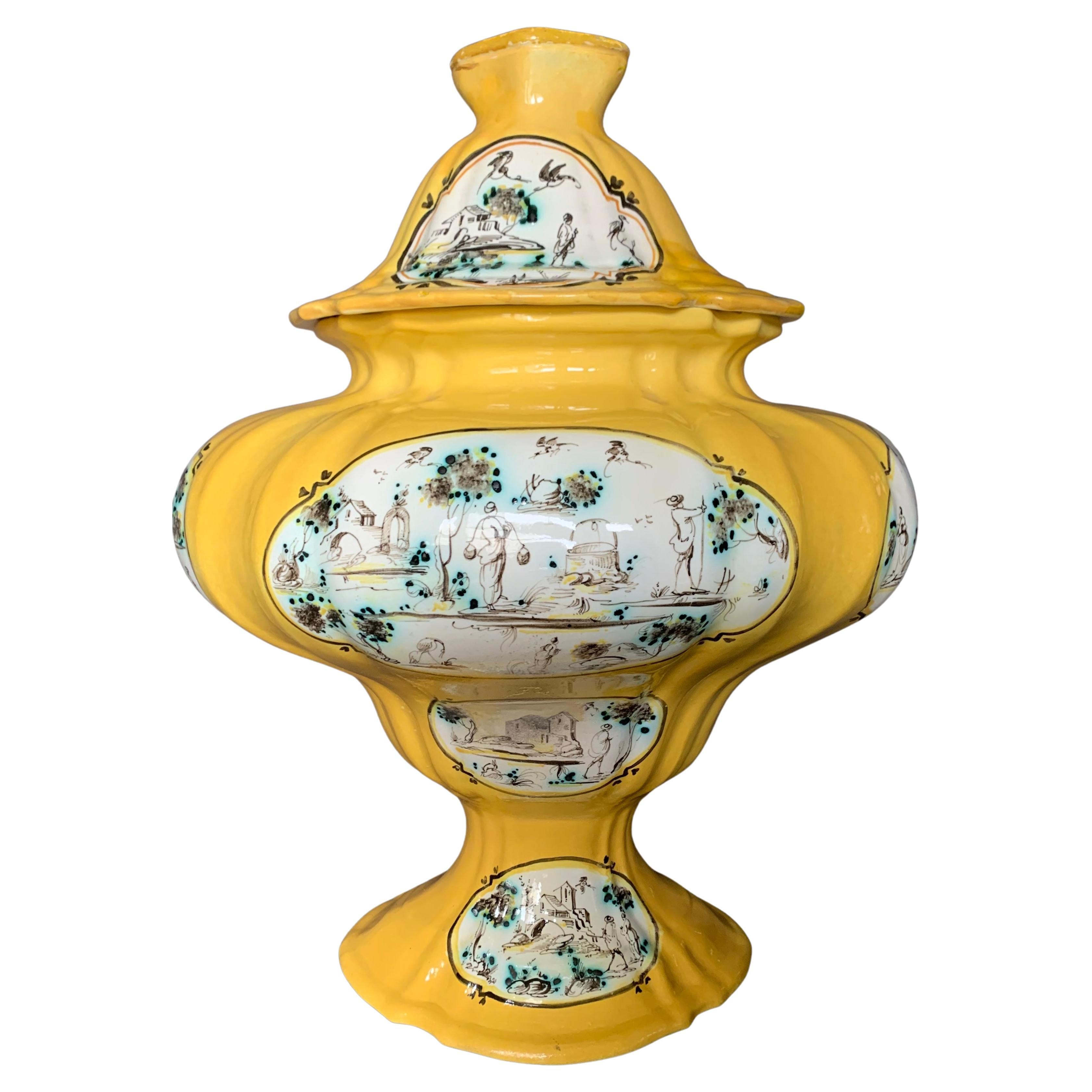 Pair of large Italian yellow faience majolica lidded urns. Striking pair of large scale baluster form urns in Levantino Albisola style with medallions depicting various rural landscapes with hunters, farmers, horse riders, etc. in sepia browns and