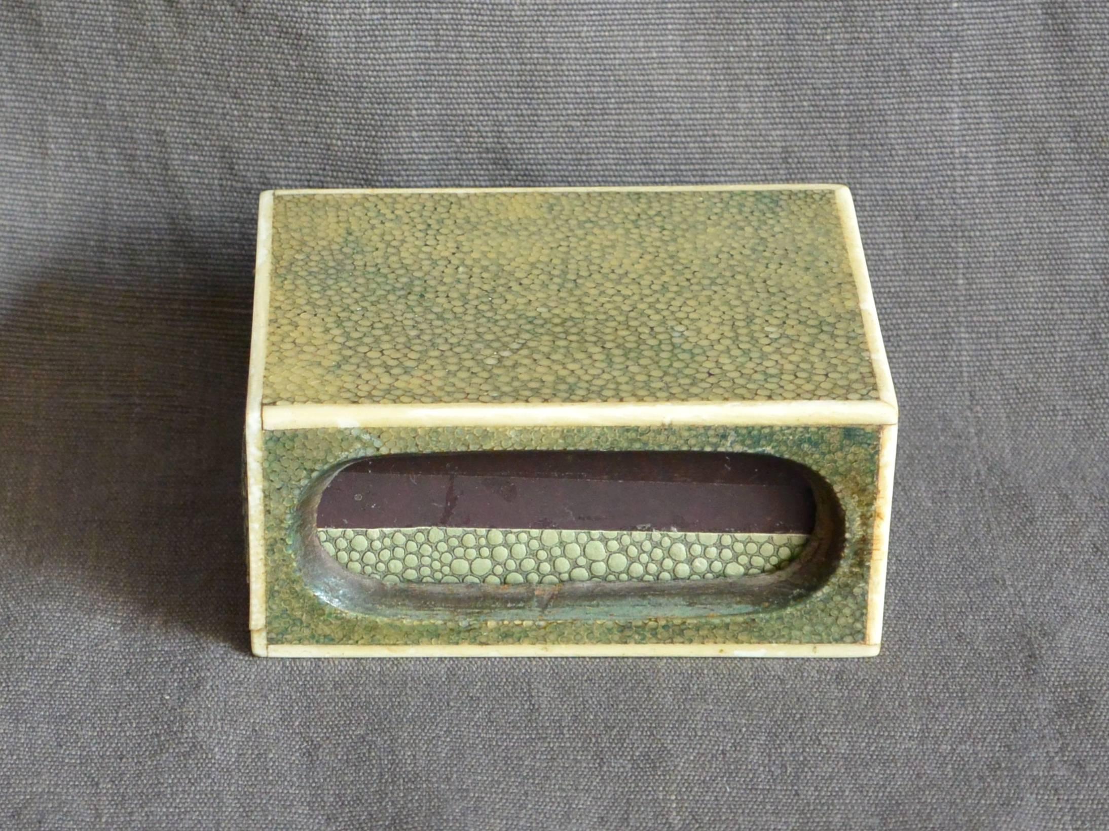 Shagreen match box . Bone trimmed celadon galuchat match box with three strike voids and paper covered match cartridge; a chic little stingray matchbox.  England, early 20th century. 
Dimension: 3