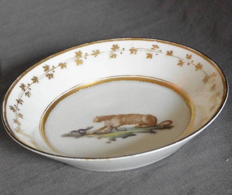 Neoclassical gilt decorated plate with puma. A Naples Real Fabbrica Ferdinandea white porcelain painted and gilt decorated saucer dish with puma confronting a serpent. Italy, circa 1795
Dimension: 5.5
