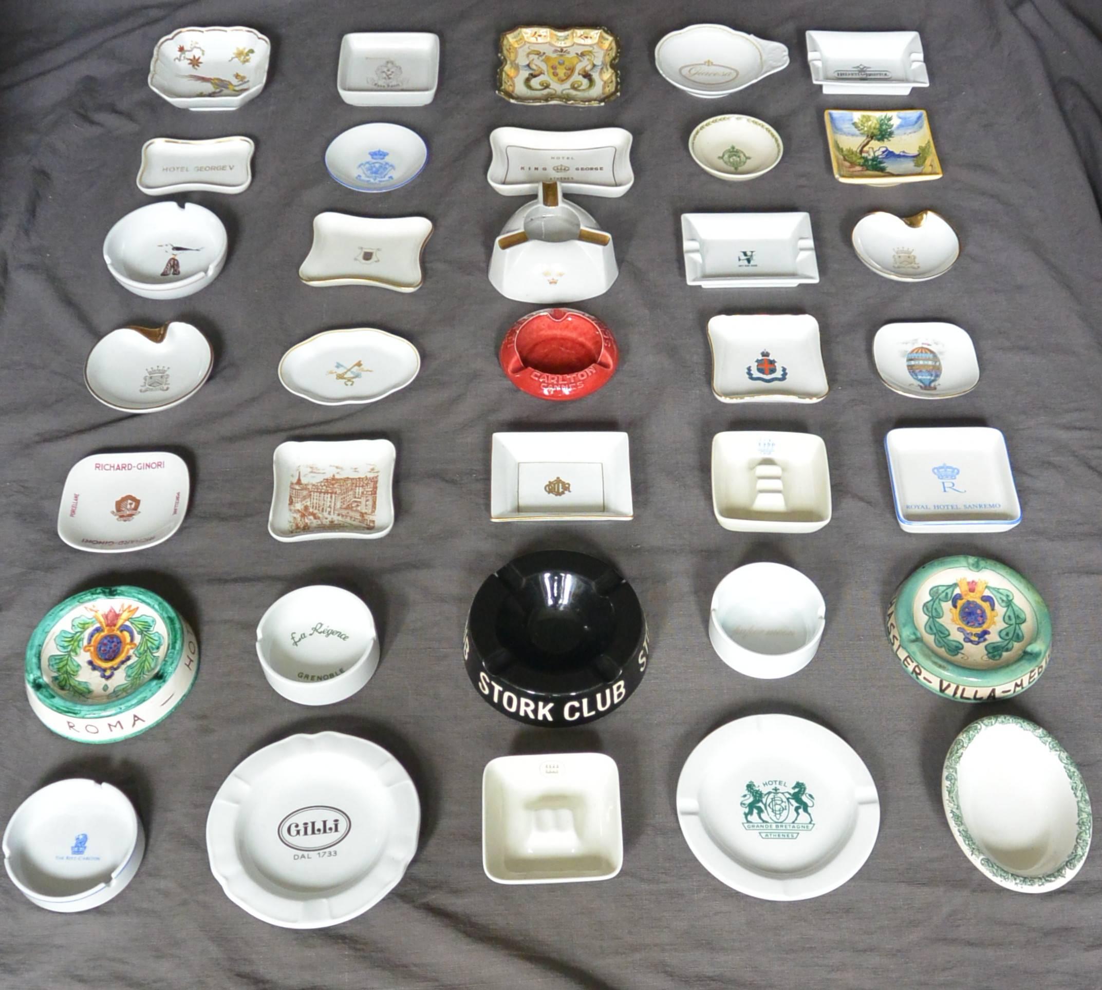 Assembled group of 35 continental and American porcelain and ceramic ashtrays from famous hotels and clubs including: Claridges, London, Hotel George V, Paris, Christian Dior, Carlton Hotel, Cannes, Palace Hotel, Madrid, Helvetia & Bristol,Florence,