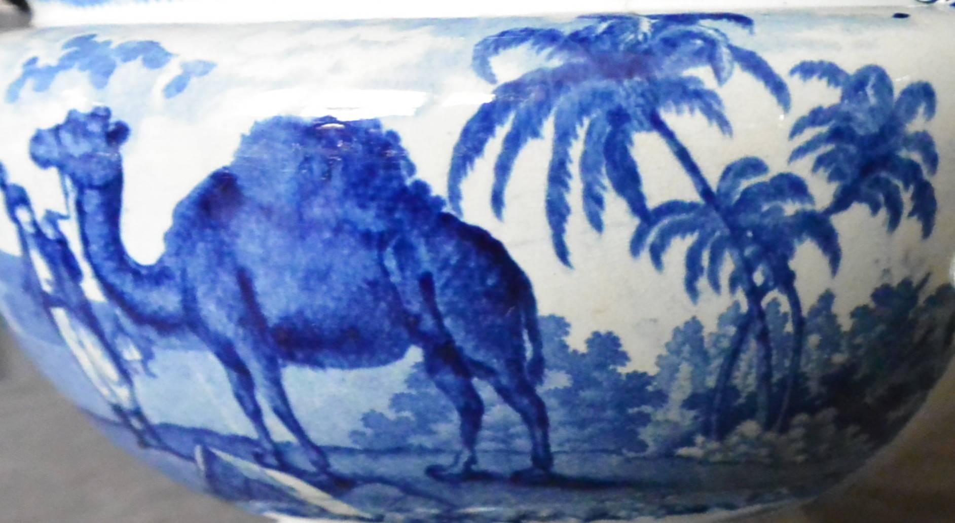 Antique blue and white handled open serving bowl with Arabian camels, palm trees and men in Turkish costume in a landscaped English park. Enoch Wood & Sons, England, circa 1825.
Dimension: 15.75