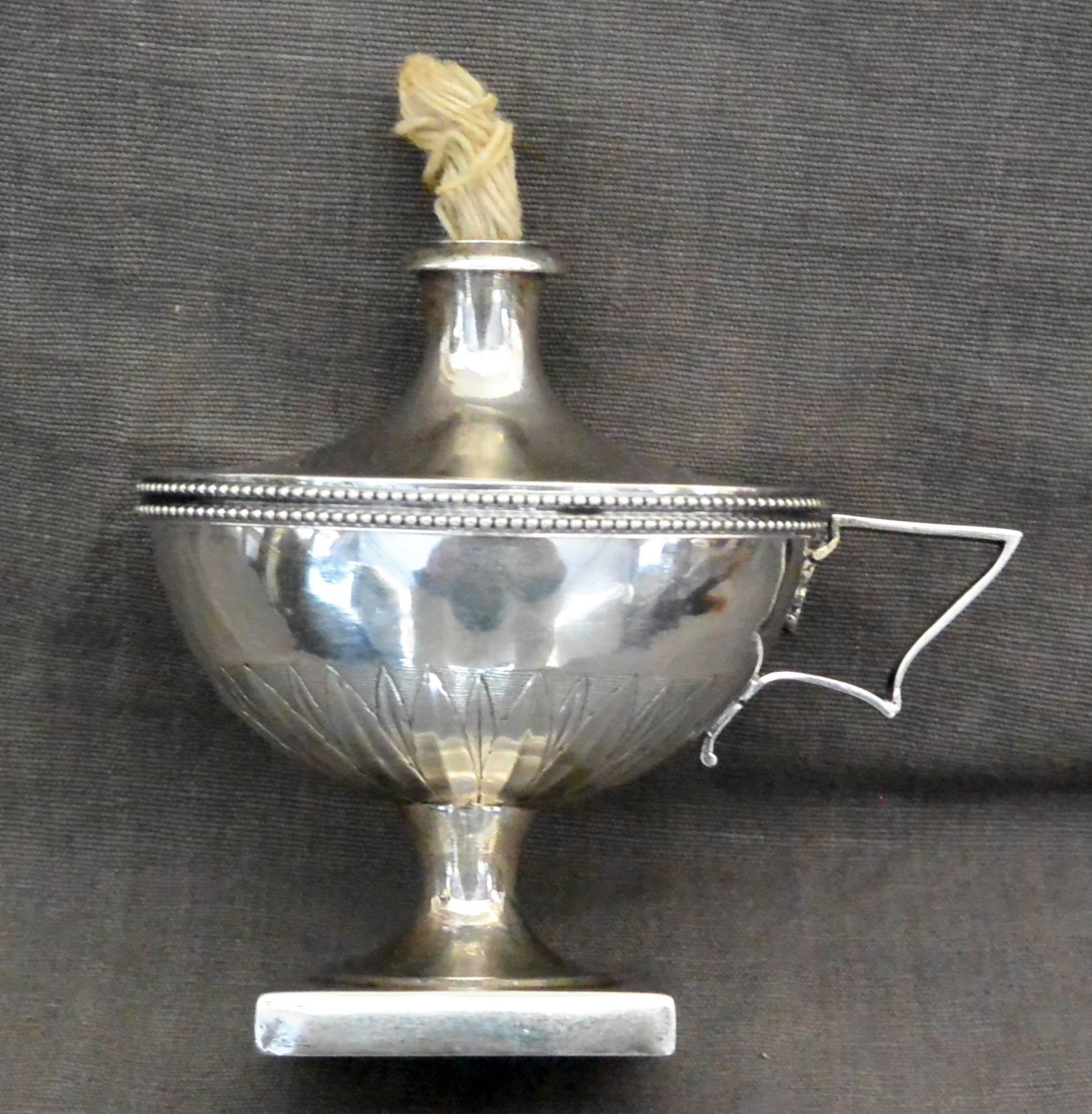 French Neoclassical Silver Oil Lamp. Antique French sterling silver oil lamp of neoclassical form with leaf and bead detailing on raised pedestal. French silver hallmarks, France, early 1800s. 
Dimension: 4.25