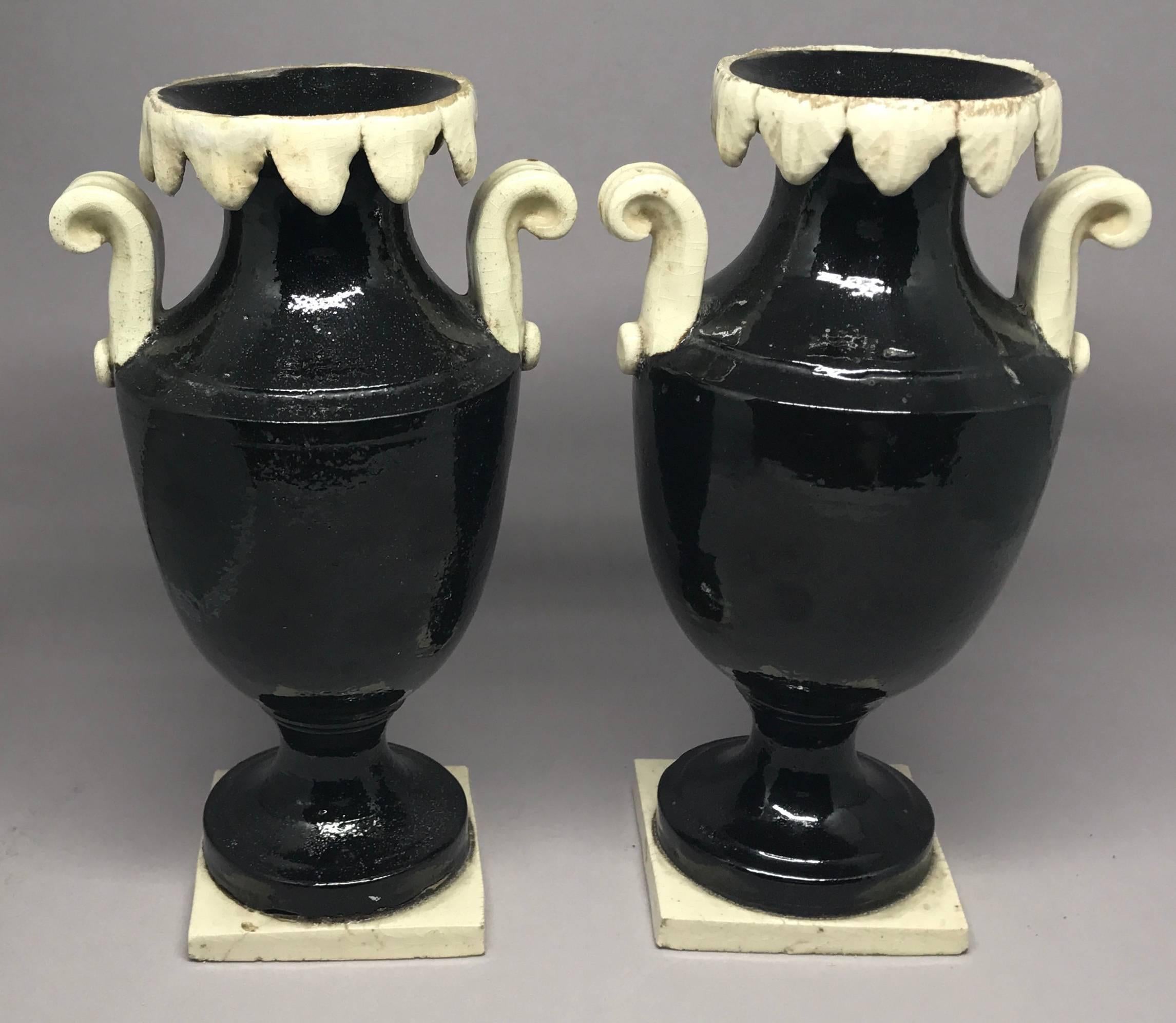 Pair of neoclassical black and white Giustiniani urns with contrasting foliate rims and scrolled handles on low plinths. Italy, circa 1780s.
Dimensions: 7.75