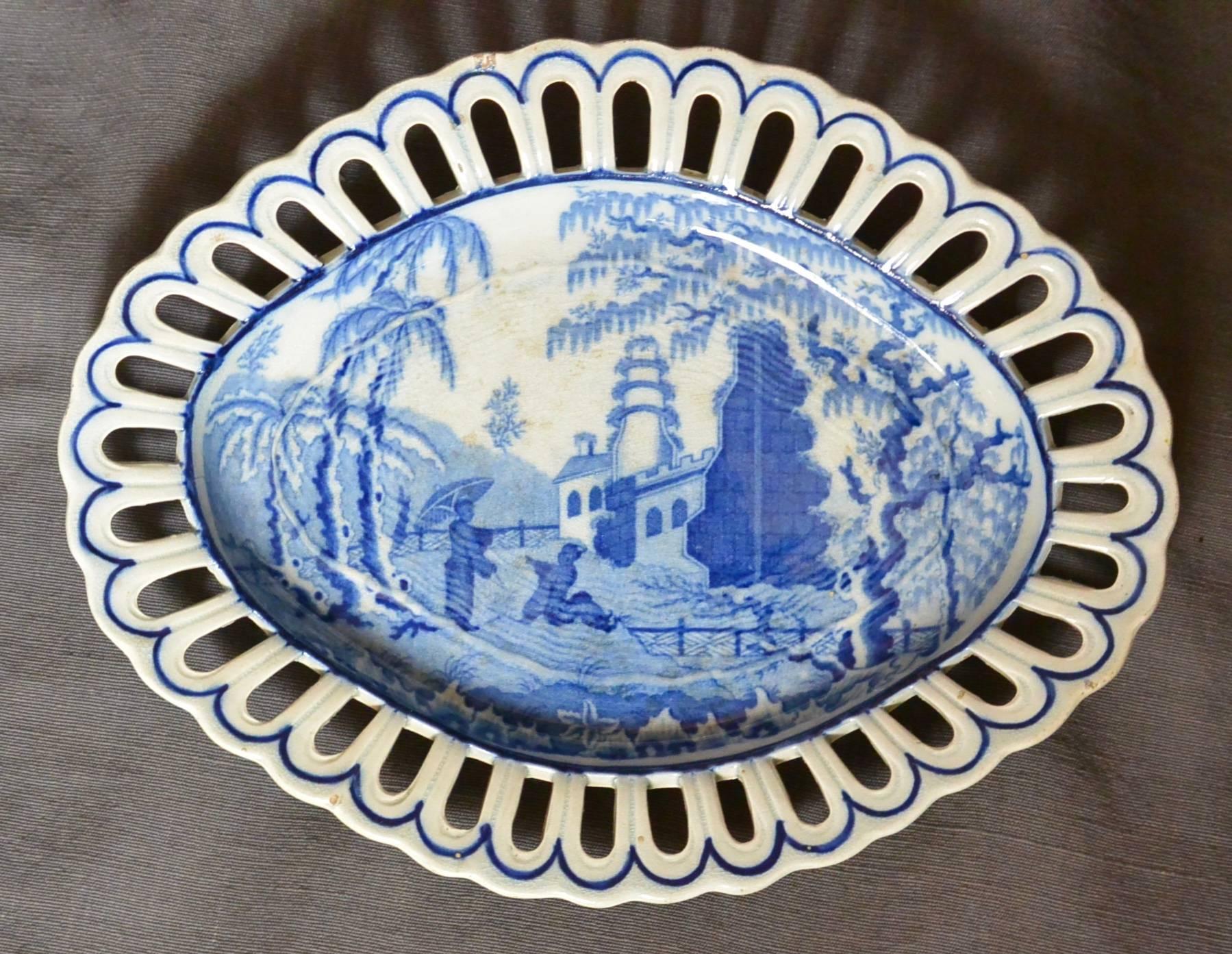 English blue and white chinoiserie plate.  Davenport Staffordshire oval plate in the "Chinoiserie Ruins" pattern with reticulated border. Ex-museum collection. England, circa 1810.
Dimensions: 10" L x 7.75" W x 1.13" D.