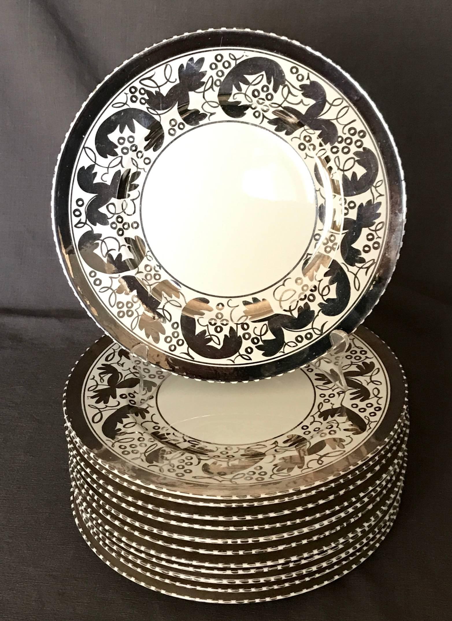 Set of twelve vintage Wedgwood platinum dinner plates in the original Amherst pattern. Large dinner size with hand-painted platinum band and stylized grape leaf border. Impressed marks for Wedgwood. England, circa 1929
Dimensions: 10.88