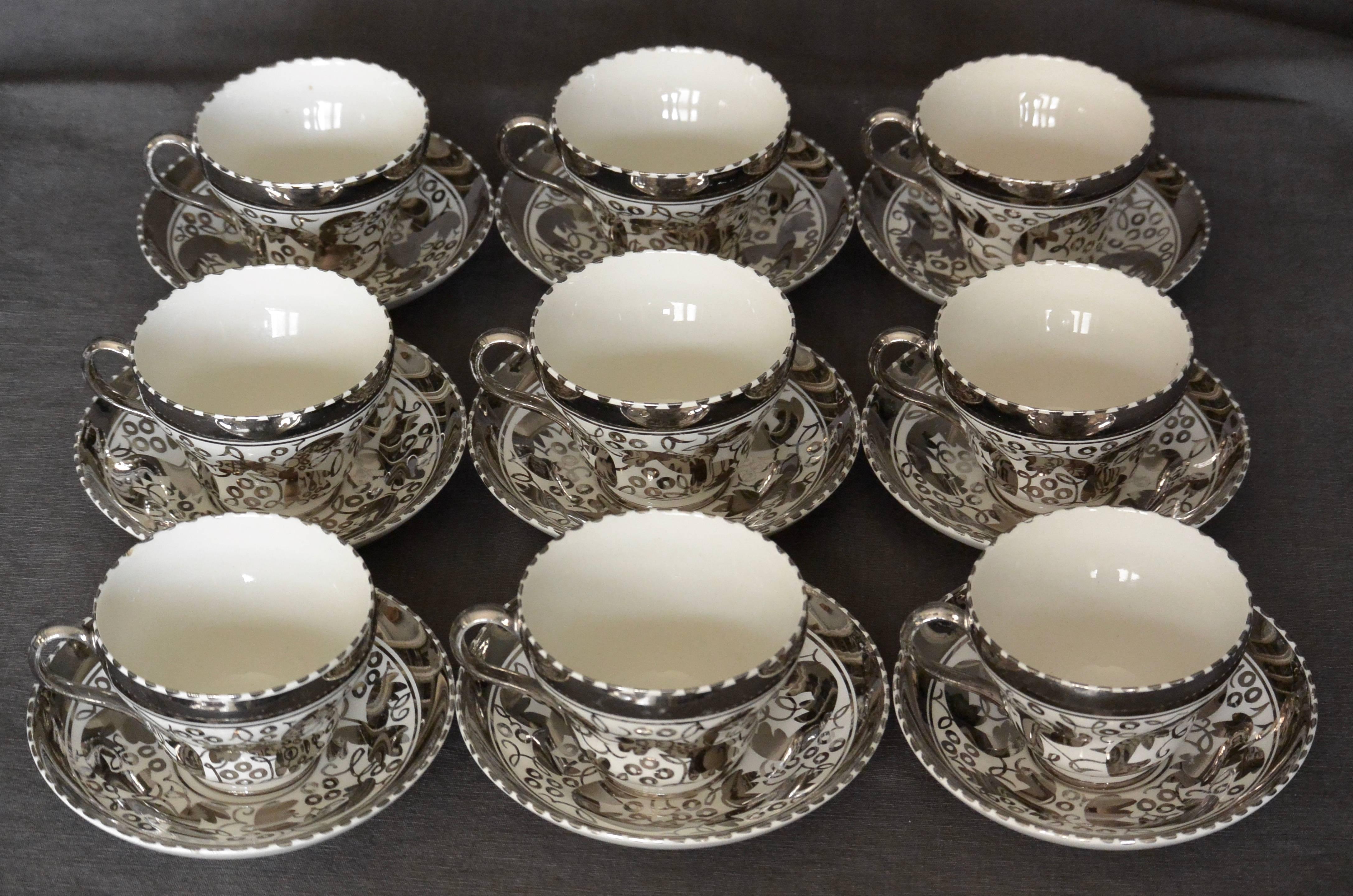 Set of nine vintage Wedgwood platinum cups and saucers in the original Amherst pattern. Cups and saucers with hand-painted platinum band and stylized grape leaf border. Impressed marks for Wedgwood, England, circa 1929
Dimensions: cup 2.5” H x 3.5”