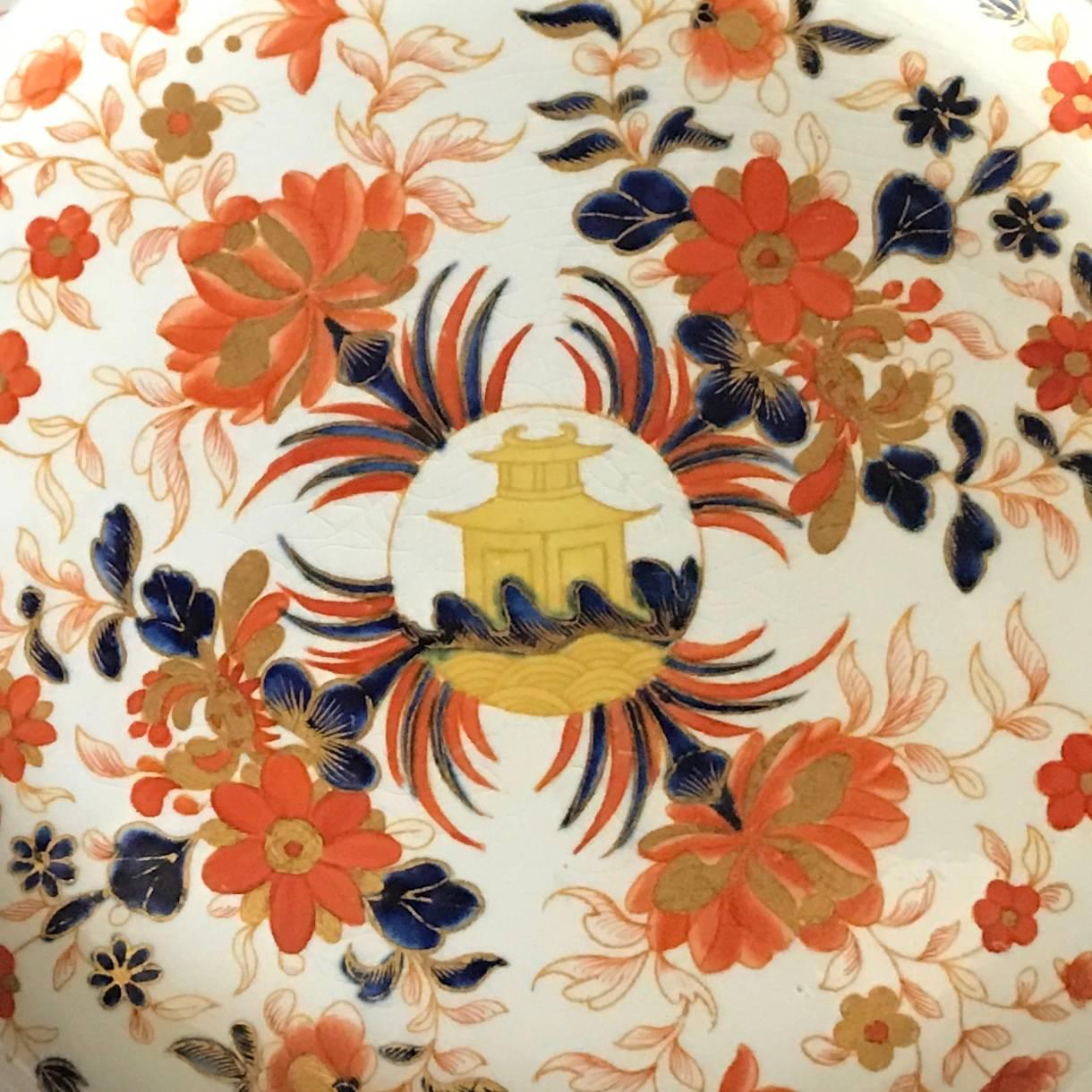 Wedgwood pearlware Imari decorated in gilt, cobalt blue, iron red and peach chinoiserie flowers with a central yellow pagoda medallion, England, mid-19th century.
Dimensions: 9.88