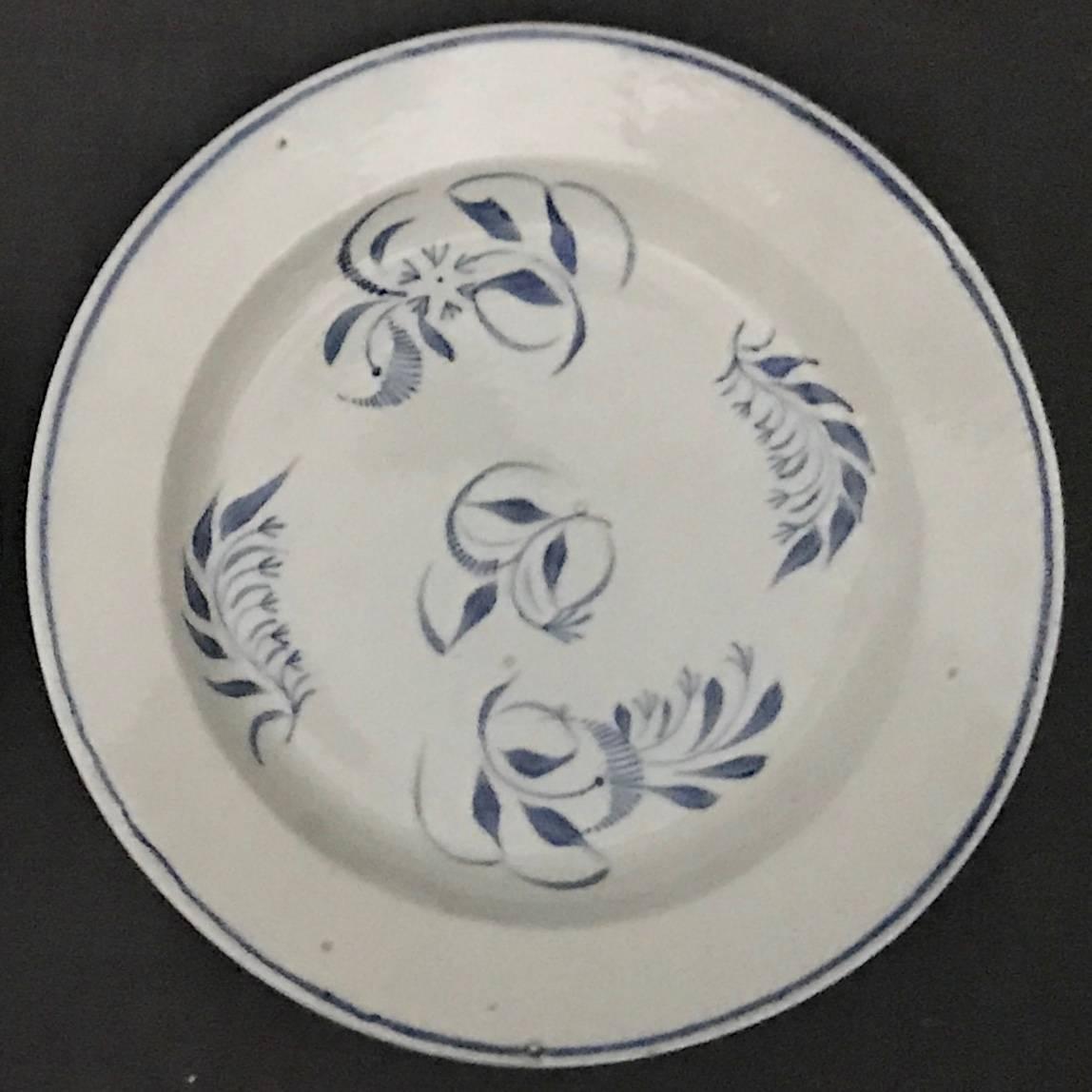 Pair of blue and white French cream-ware plates. Hand-painted blue floral sprigs and border on shallow rimmed cream paste ceramic plates. France, early 19th century. 
Dimensions: 8.63