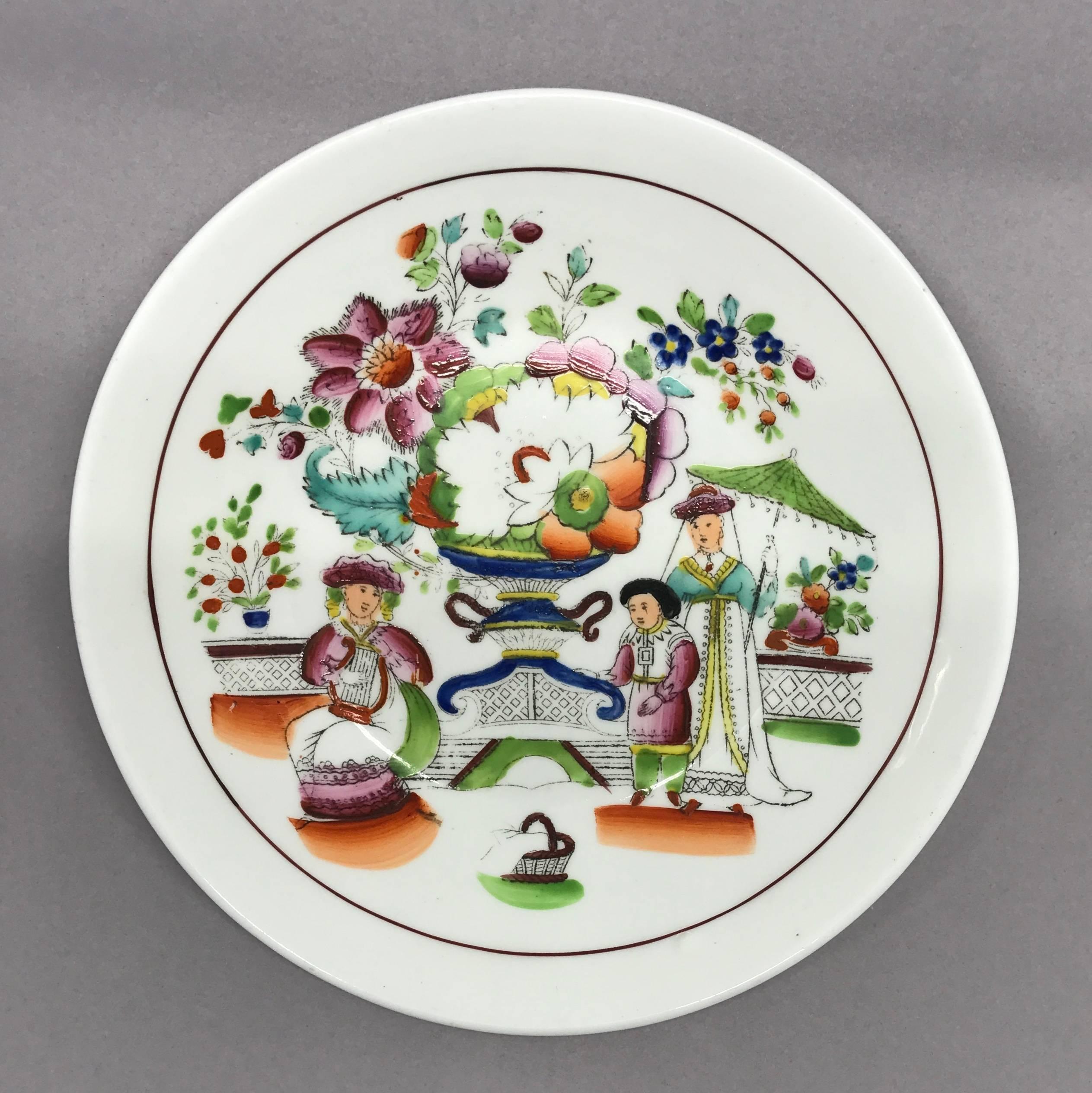 Small English chinoiserie plate. William IV Staffordshire plate with charming brightly hued oriental themed scene of figures with parasol,, hamper and large blooms in a garden setting, England, circa 1820.
Dimensions: 5.63