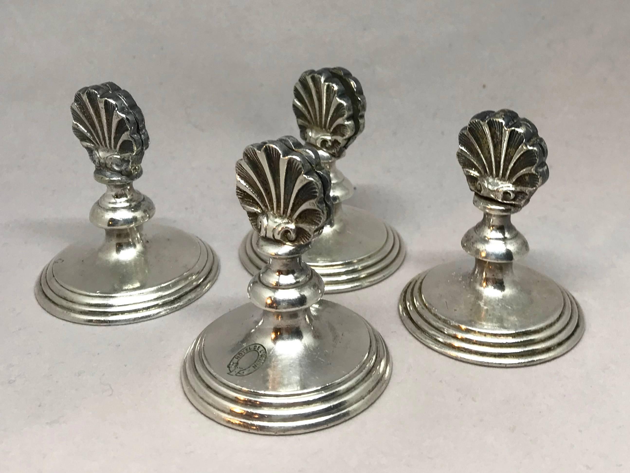  Austrian hotel silver place card holders. Set of four deco period silver plate place card holders in the form of shells, one stamped Hotel de L'Union. Stamps for Art.Krupp Berndorf with bear insignia. Austria, circa 1930.
Dimensions: 2" Dia x
