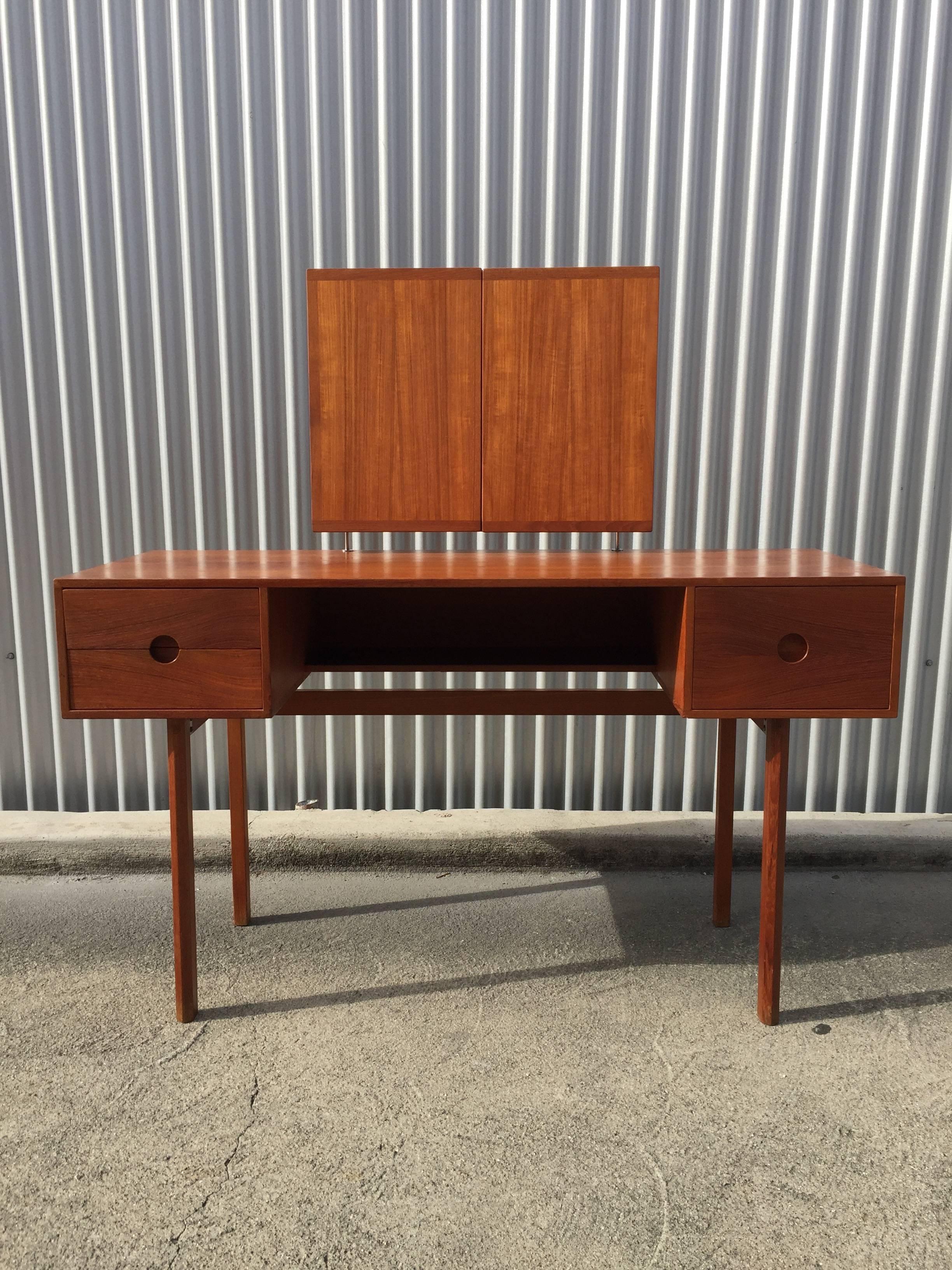 Manufactured by Odder, Denmark. Vanity with adjustable, folding, and floating mirror. Teak. Mint original condition.